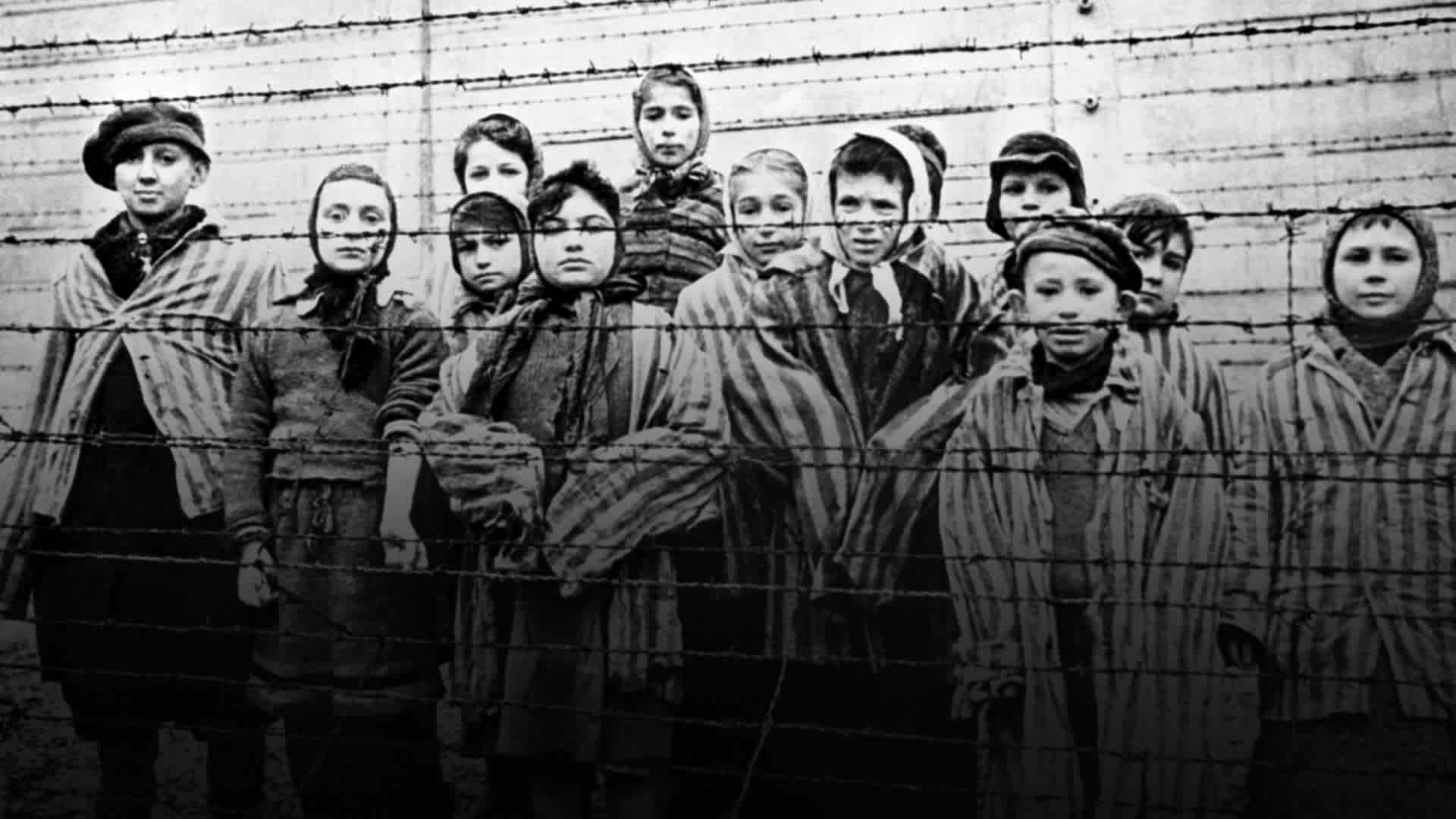 A group of child survivors behind a barbed wire fence at the Nazi concentration camp at Auschwitz-Birkenau in southern Poland, on the day of the camp’s liberation by the Red Army, 27th January 1945.