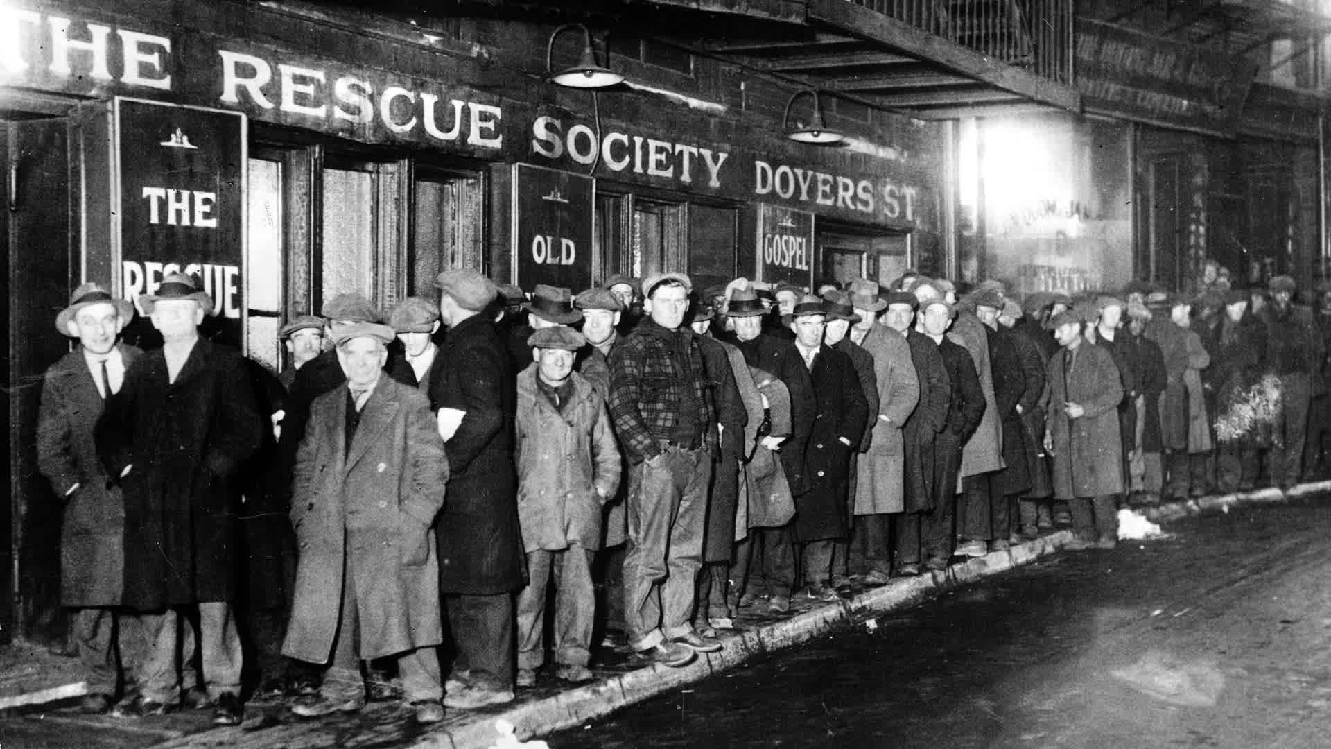 New York, USA 1931. New Yorkers celebrated Christmas in 1931, with a city-wide solicitude for those touched by misfortune during the year. The Municipal Lodging House fed 10,000 persons, including about 100 women and the Police Glee Club and the Police BNew York, USA, 1931, New Yorkers celebrated Christmas in 1931, with a city-wide solicitude for those touched by misfortune during the year, The Municipal Lodging House fed 10,000 persons, including about 100 women and the Police Glee Club and the Police Band entertained them, Here a line of hungrey men waiting to enter the Municipal Lodging House on East 25th street (Photo by Rolls Press/Popperfoto via Getty Images/Getty Images)