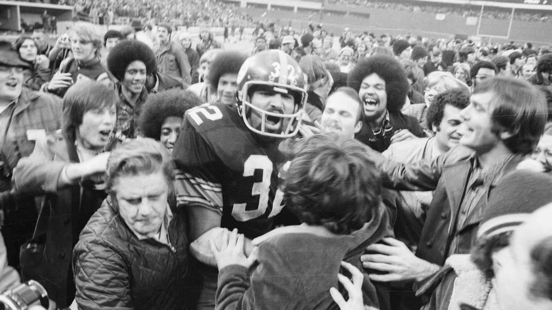 Pittsburgh Steelers fans mobbed rookie Franco Harris after he scored on the "Immaculate Reception."
