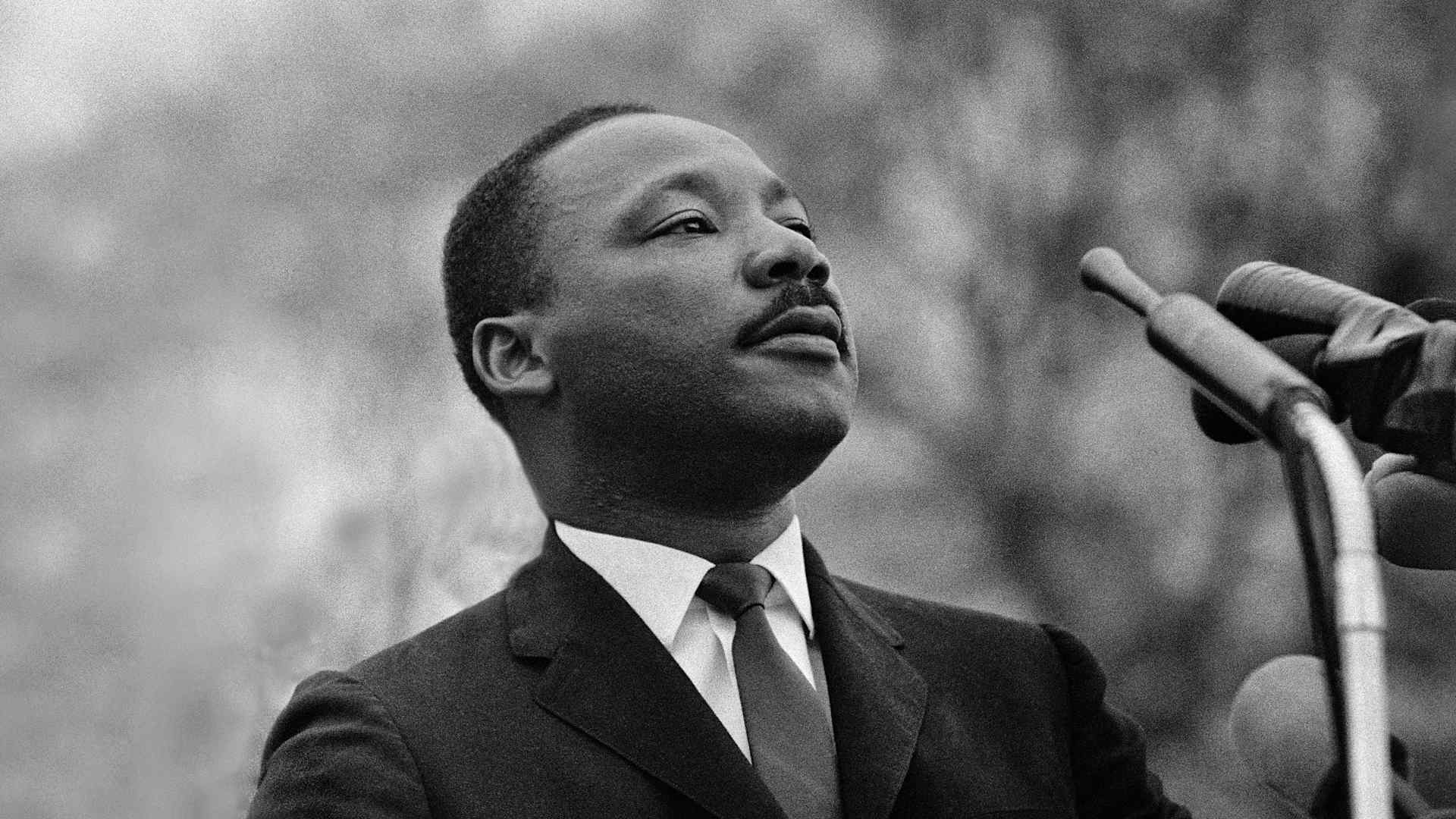 Dr. Martin Luther King, Jr. speaking before crowd of 25,000 civil rights marchers in front of the Montgomery, Alabama state capital building on March 25, 1965.