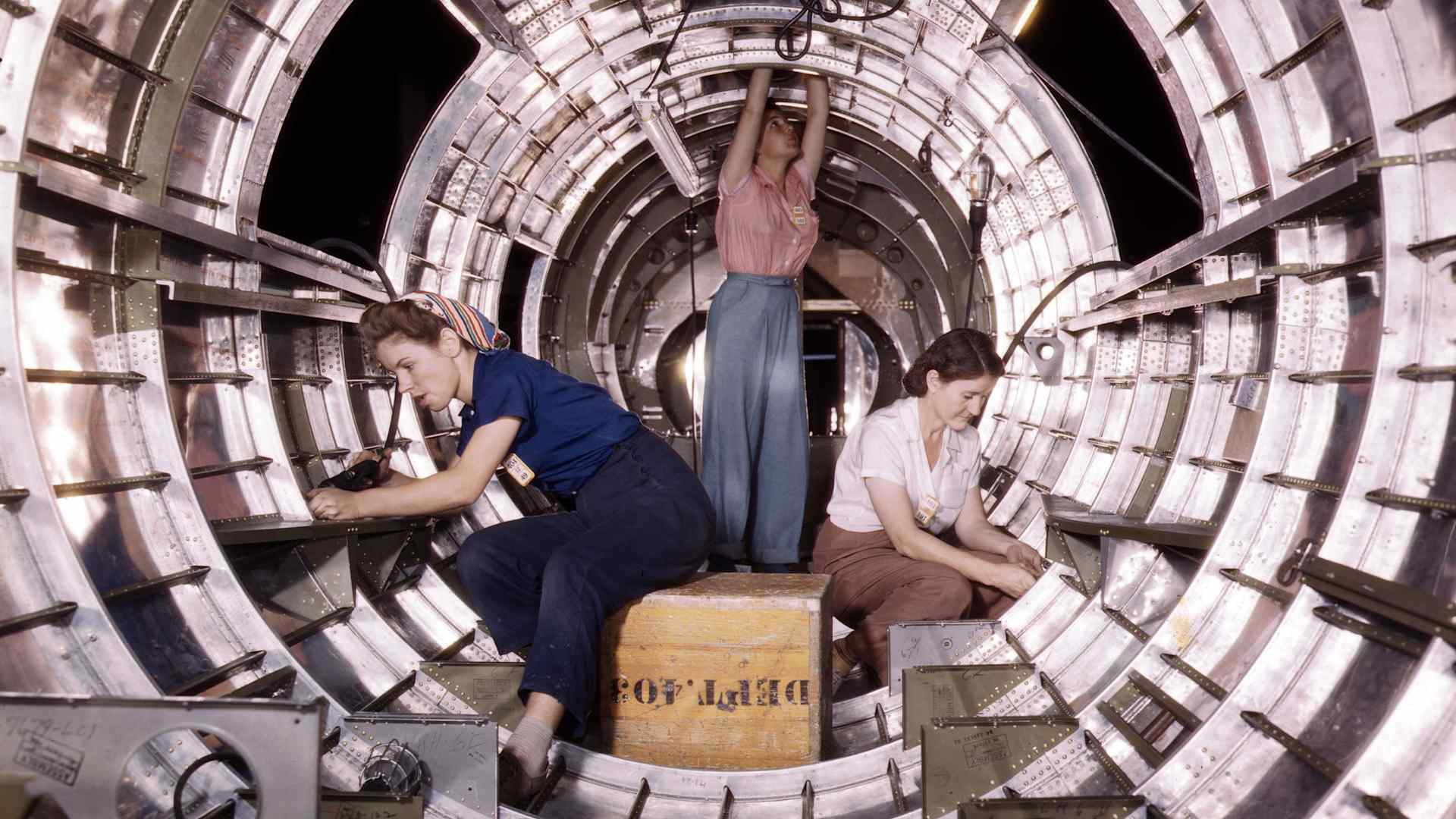 Women workers install fixtures and assemblies to a tail fuselage section of a B-17 bomber at the Douglas Aircraft Company plant in Long Beach, California.