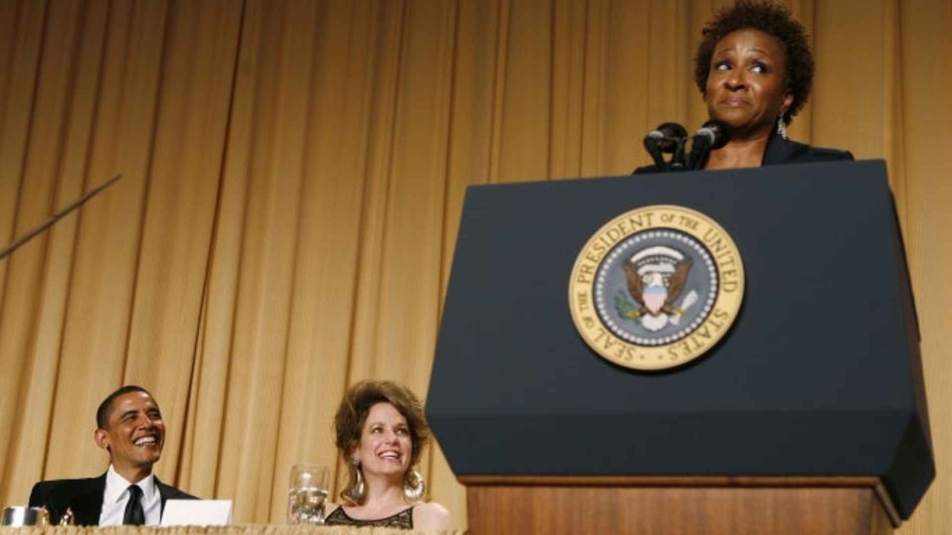 President Barack Obama and journalist Jennifer Loven listen to comedian Wanda Sykes at the White House Correspondents’ Dinner in 2011.