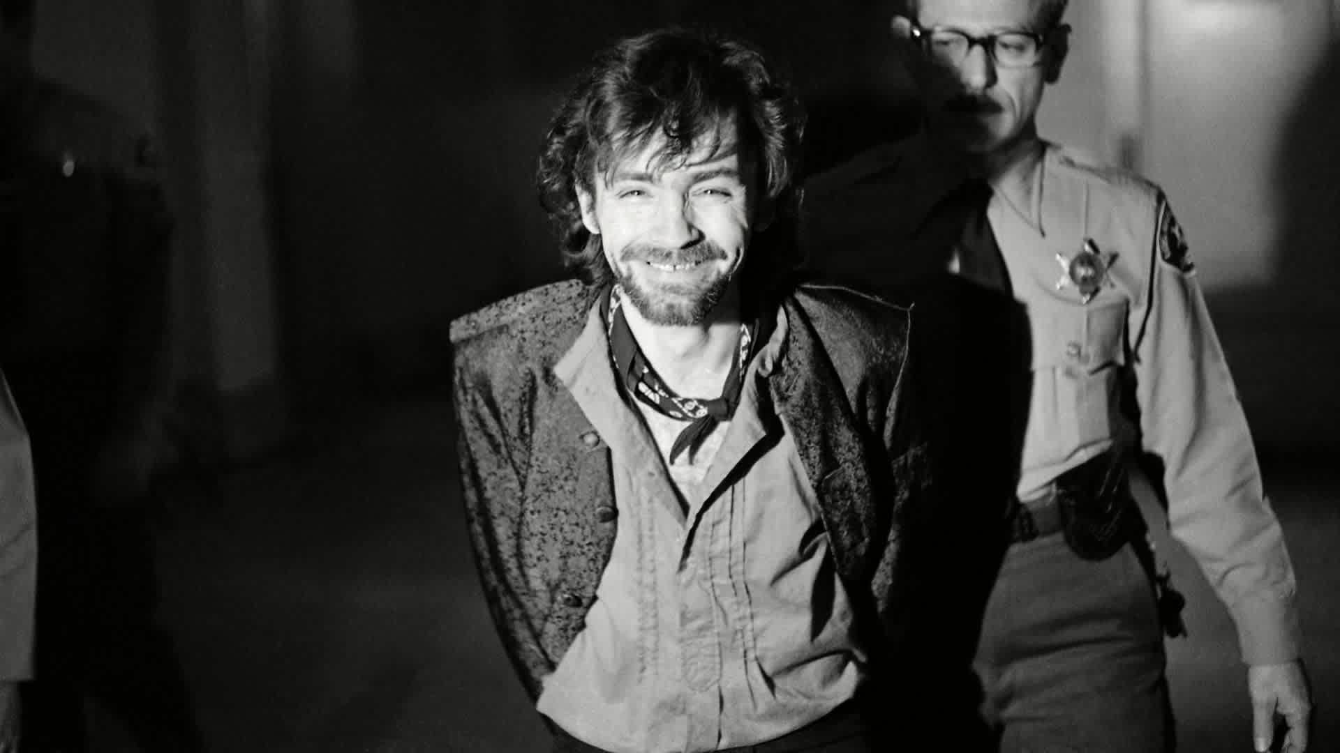 A smiling Charles Manson during a break in the Tate murder trial after an outburst from his co-defendants. The trouble started after Leslie Van Houten said she wanted to fire her new lawyer, then slapped a bailiff and told the judge, "I'd strike you if I could" before being ejected from the courtroom. (Credit: George Brich/AP/REX/Shutterstock)