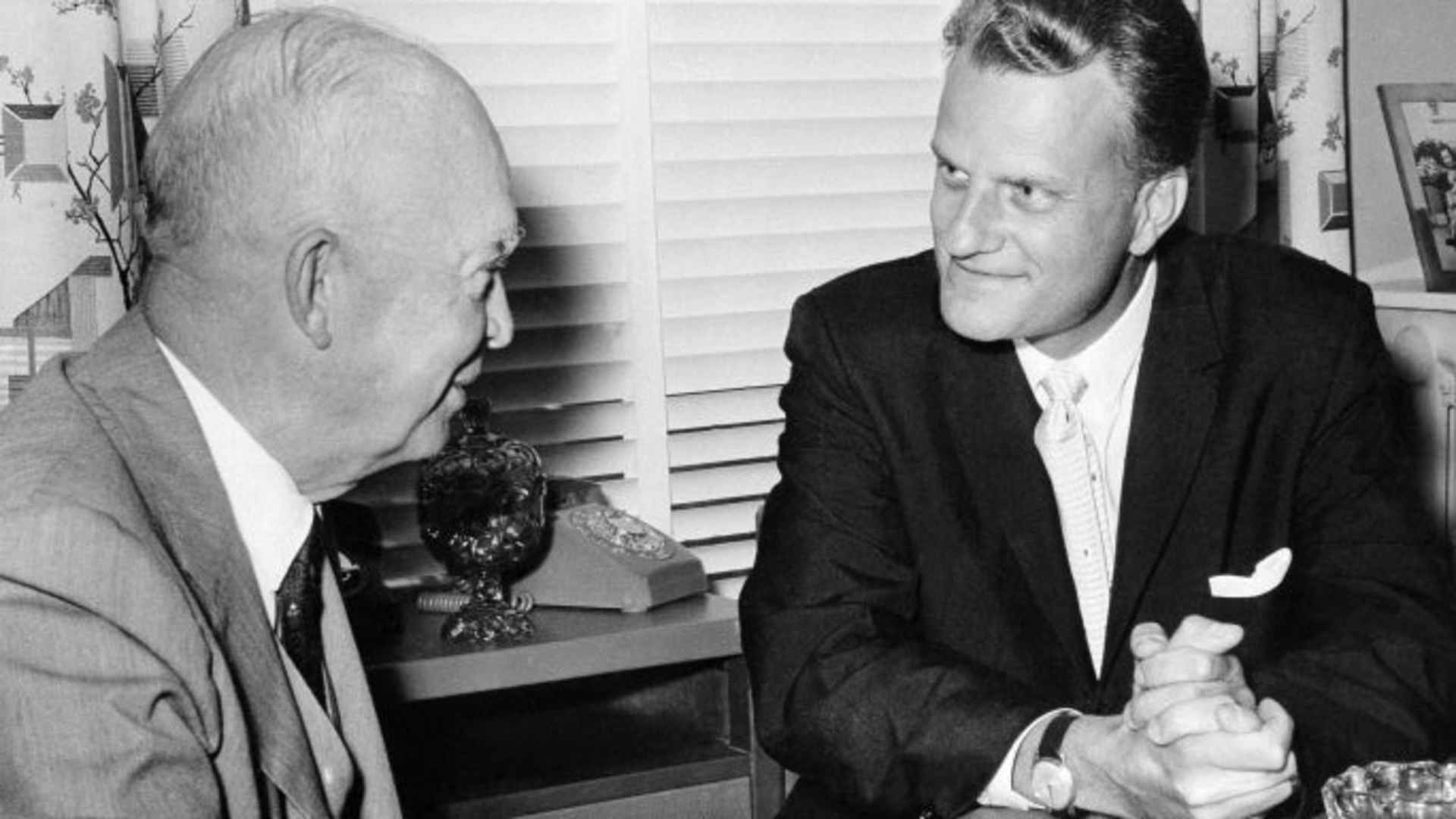 President Dwight D. Eisenhower meeting with Reverend Billy Graham for a personal chat, 1961. (Credit: Ziegler/AP Photo)