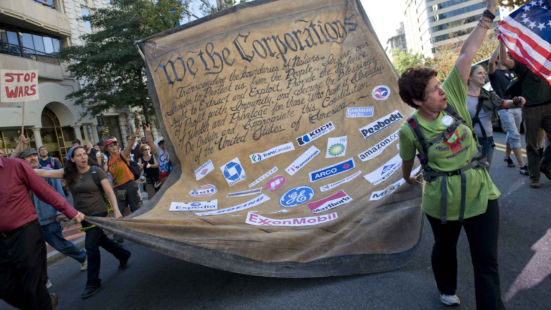 Protestors carry an altered US constitution dedicated to corporations at the 'Occupy Wall Street' protest and march down K Street in Washington, DC in 2011. Organizers protested 'corporate greed,' defense spending, banks and rising income inequality. (Credit: Linda Davidson/The Washington Post/Getty Images)