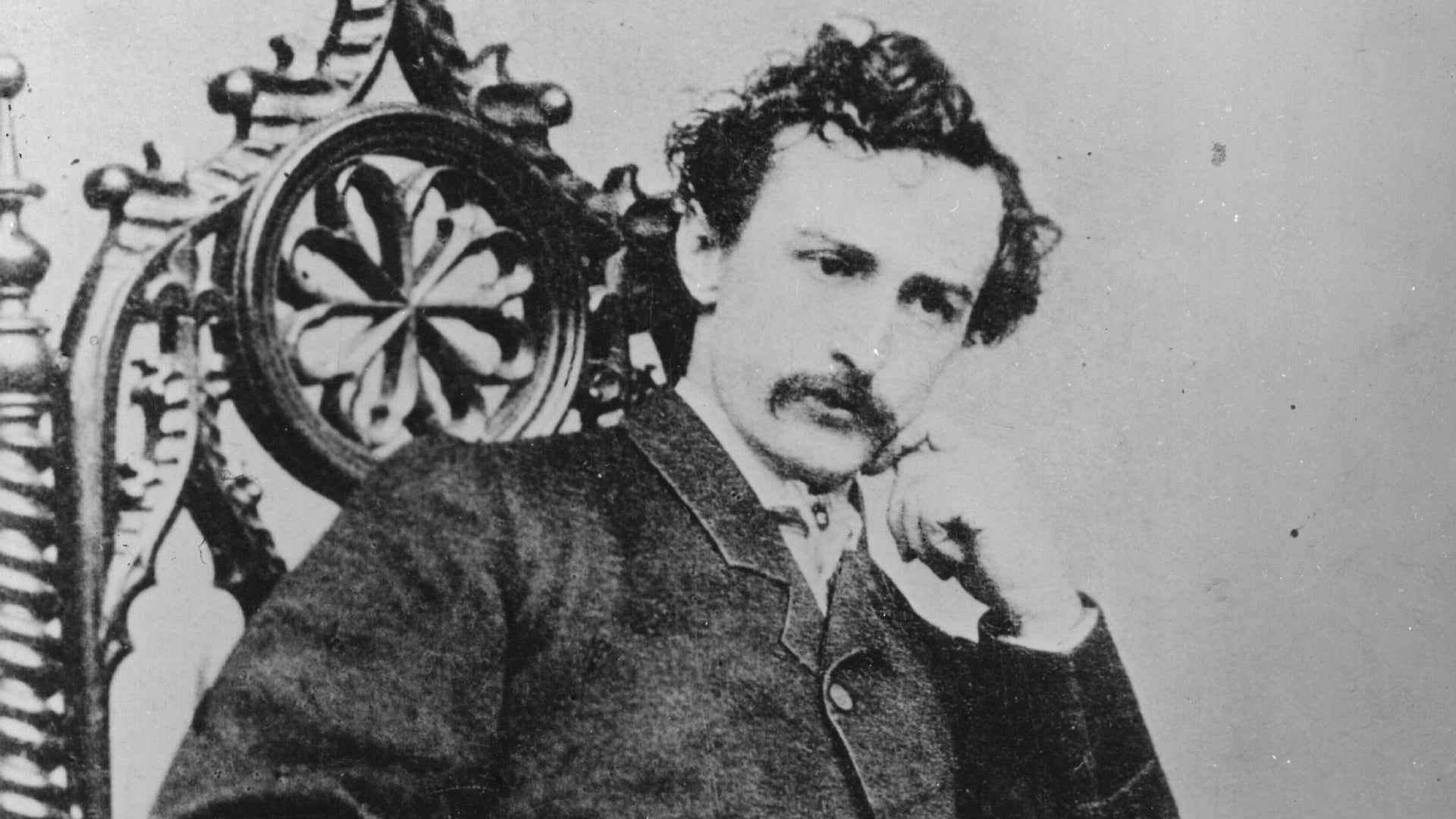 Seated portrait of John Wilkes Booth with his hand under his chin