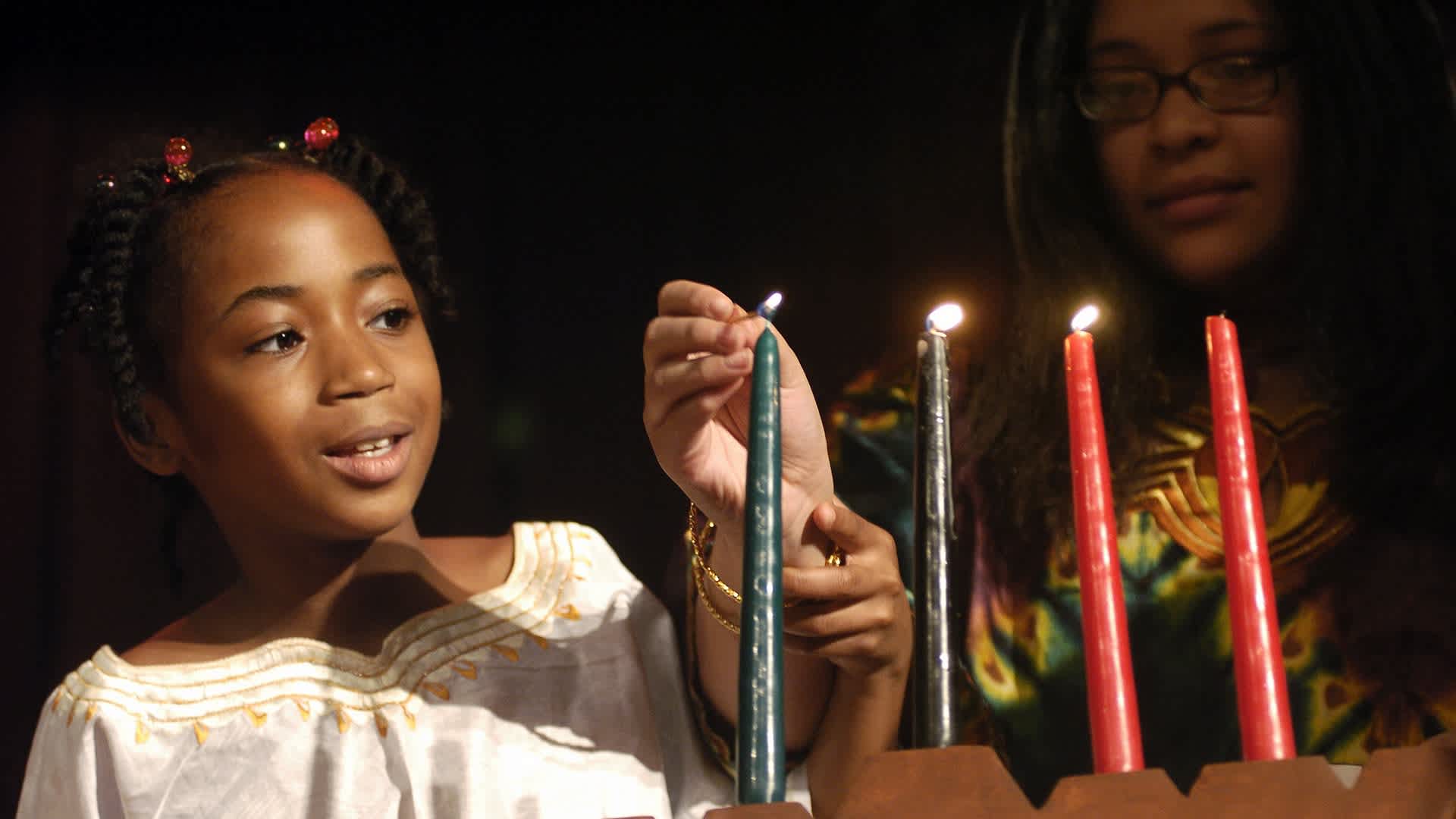 Brooklyn students light a candle celebrating Ujamaa (CooperaUNITED STATES - DECEMBER 29: Brooklyn students light a candle celebrating Ujamaa (Cooperative Economics), one of the Seven Principles of Kwanzaa, during a celebration at the American Museum of Natural History. The celebration kicks off the Museum's 2005 Kwanzaa festival, which will take place Dec. 29-31. (Photo by Linda Rosier/NY Daily News Archive via Getty Images)