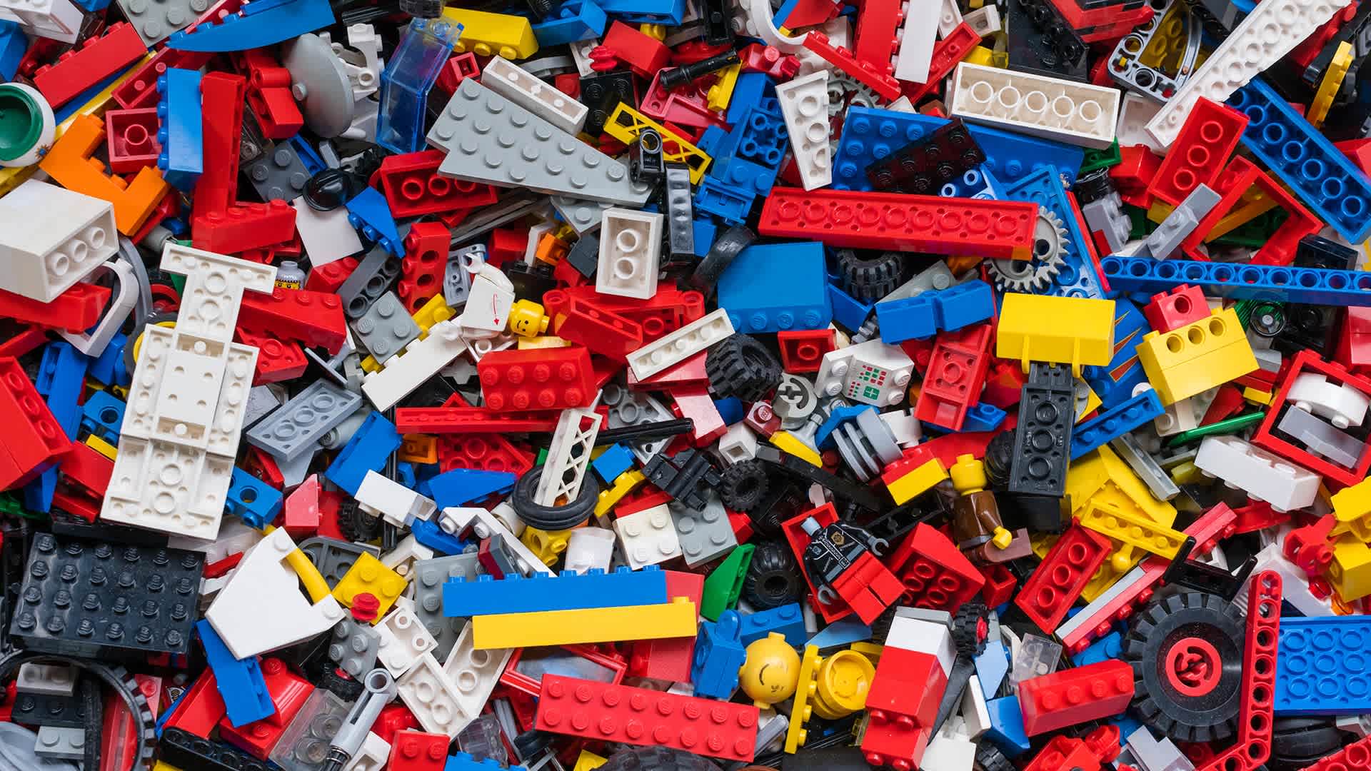 Cluttered pile of many colorful Lego bricks.
