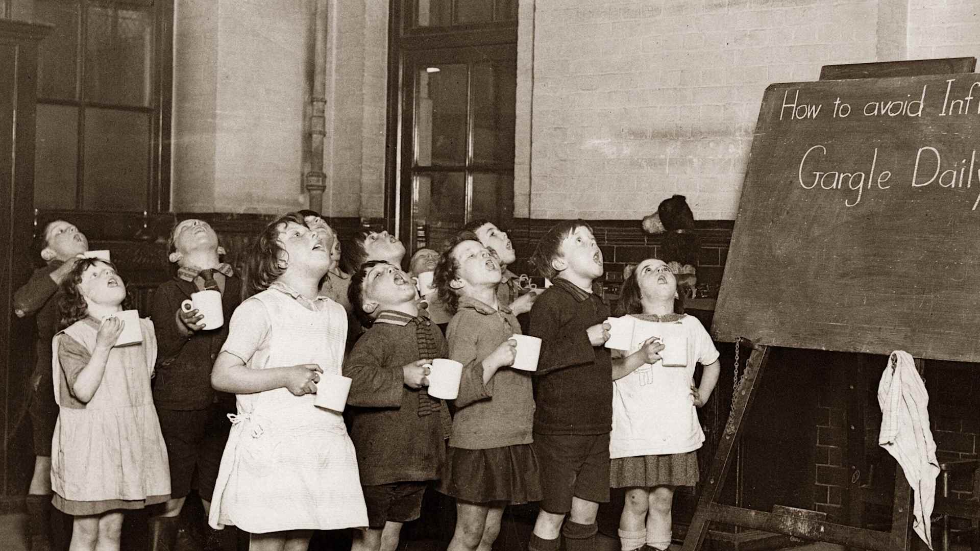 School children gargling their throats as a precaution against the Influenza epidemic, England