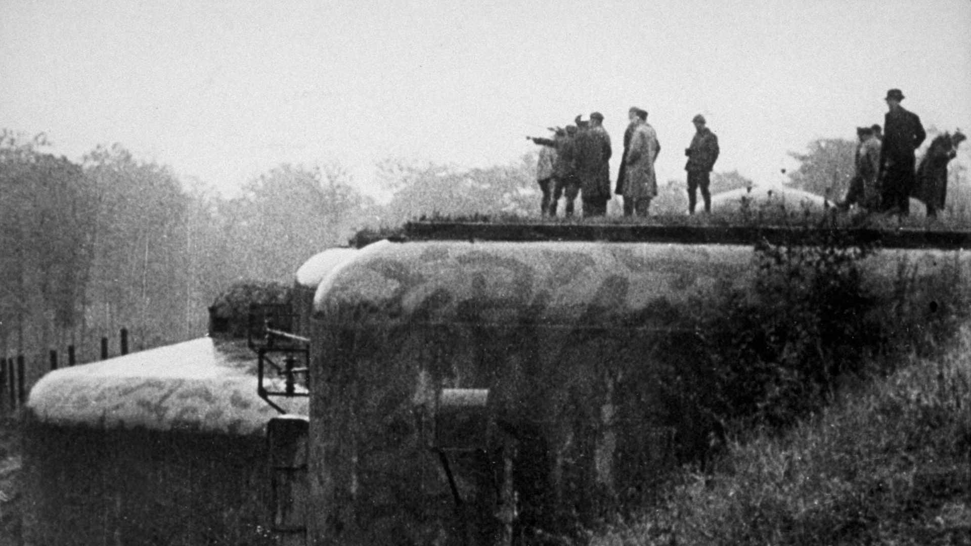 A French officer points in the direction of Berlin, from a fort on the Maginot Line, circa 1939.