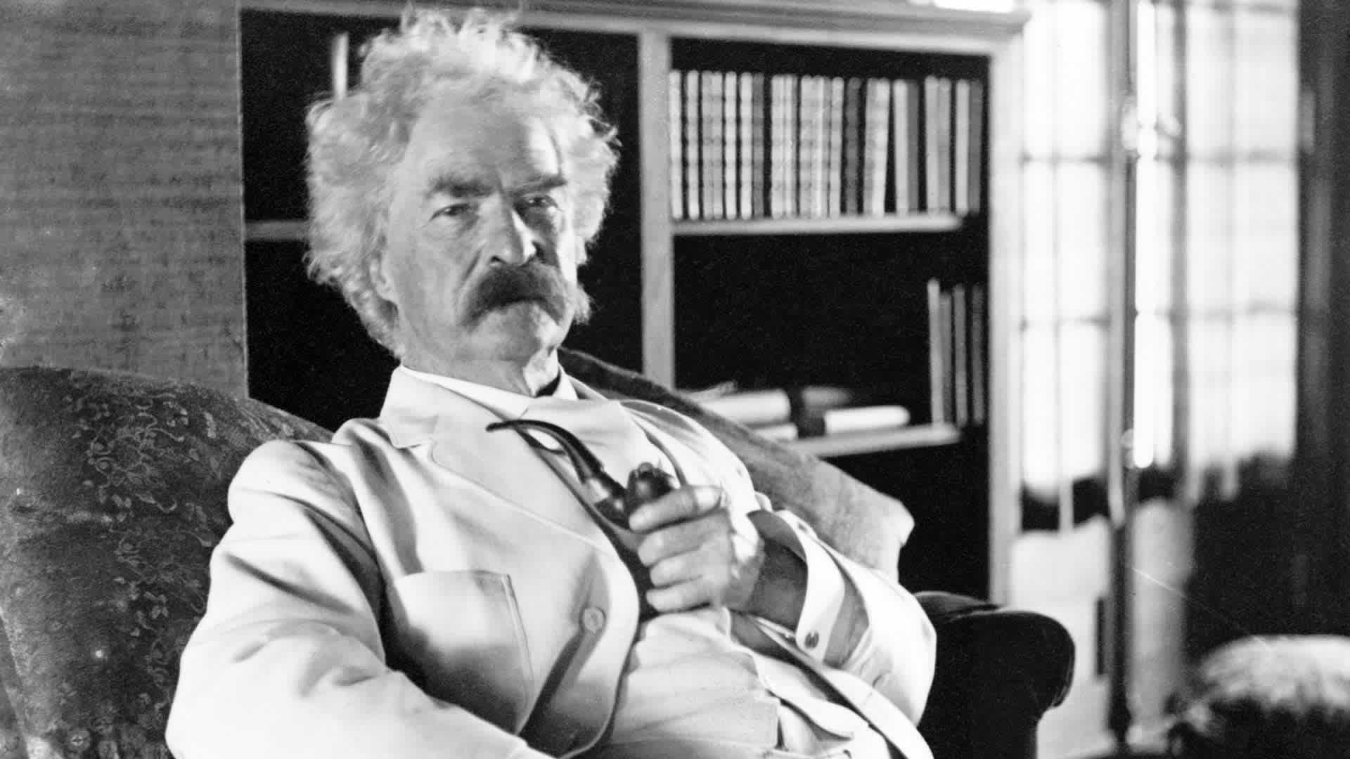 Author Mark Twain poses for a portrait in 1900.