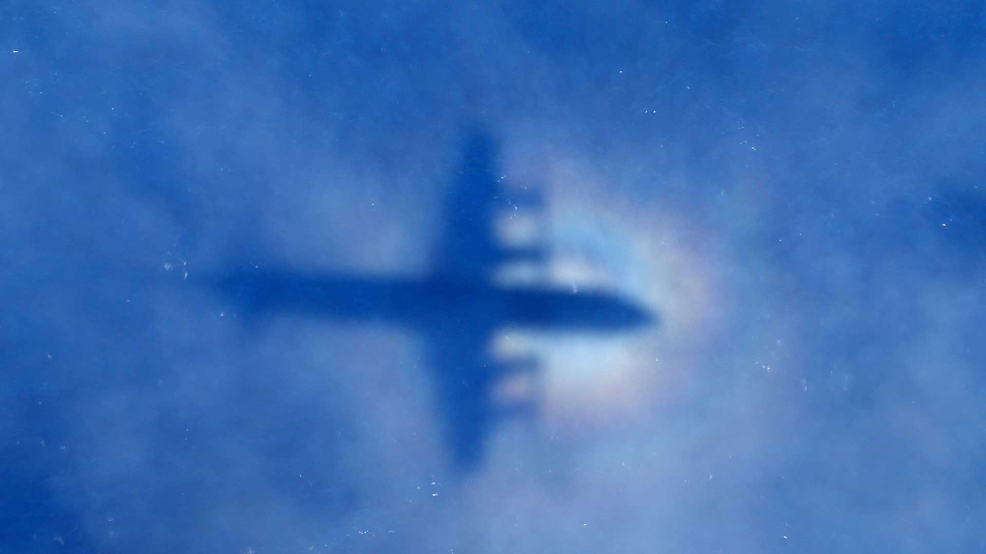 This shadow of a Royal New Zealand Air Force P3 Orion aircraft is seen as it searches for missing MH370.