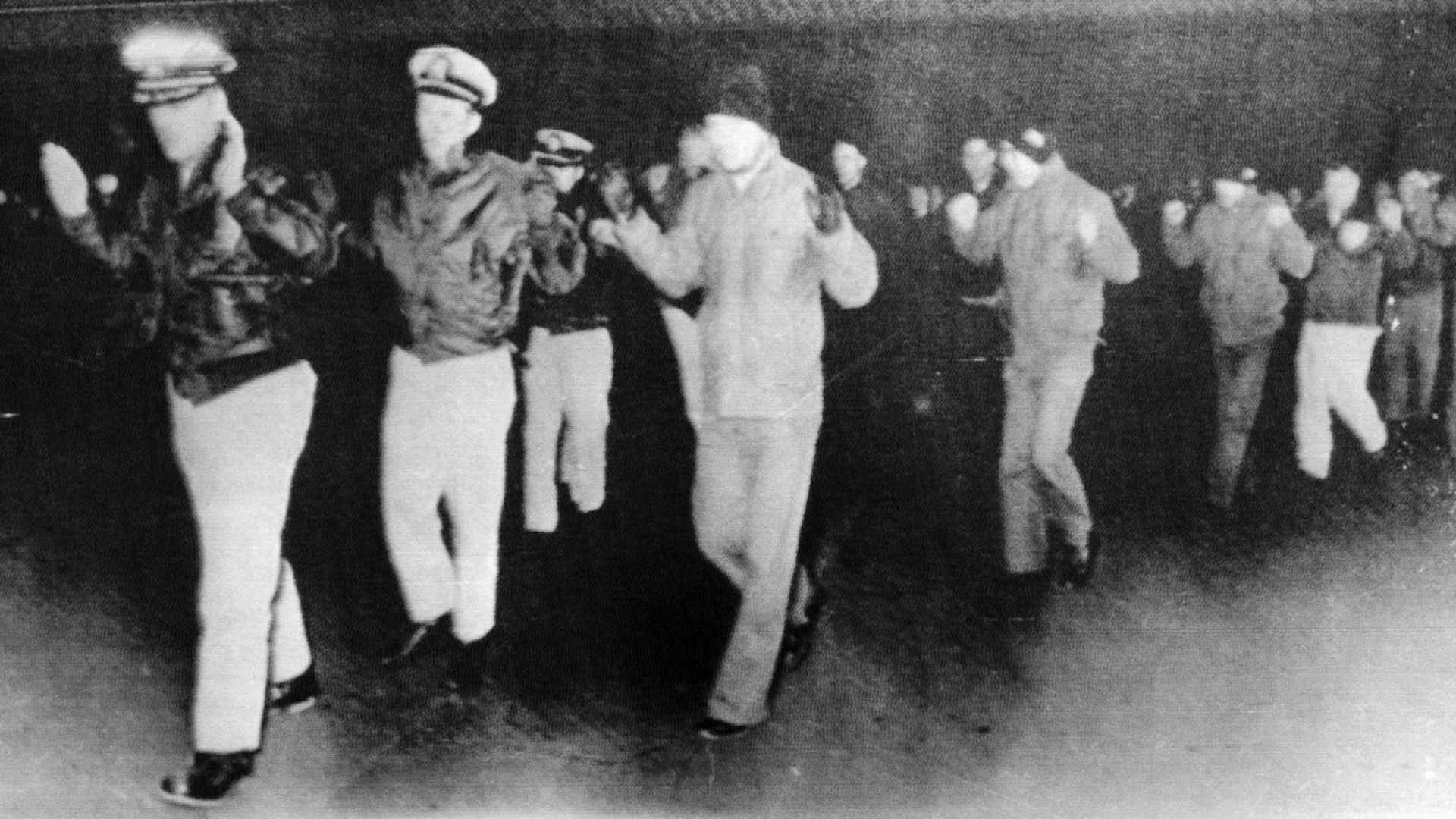 Officers and crew of the United States Navy ship U.S.S. Pueblo being led away after being captured by North Korean forces in international waters in 1968. (Credit: Bettmann Archive/Getty Images)