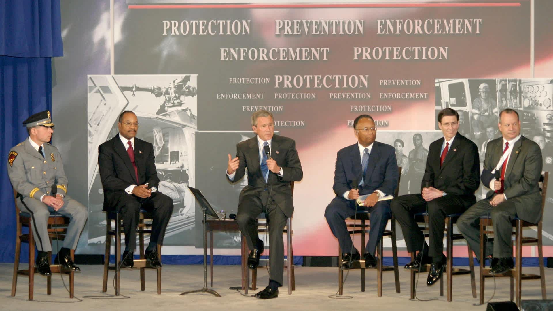 President George W. Bush - USA Patriot Act Conversation - April 20, 2004President George W. Bush spoke alongside a local panel of John Moslow of the Amherst Police Department, Mike Battle, Larry Thompson, Jim McMahon and Peter Ahearn regarding the USA Patriot Act on April 20, 2004 in Buffalo, New York. (Photo by Marc Andrew Deley/FilmMagic)