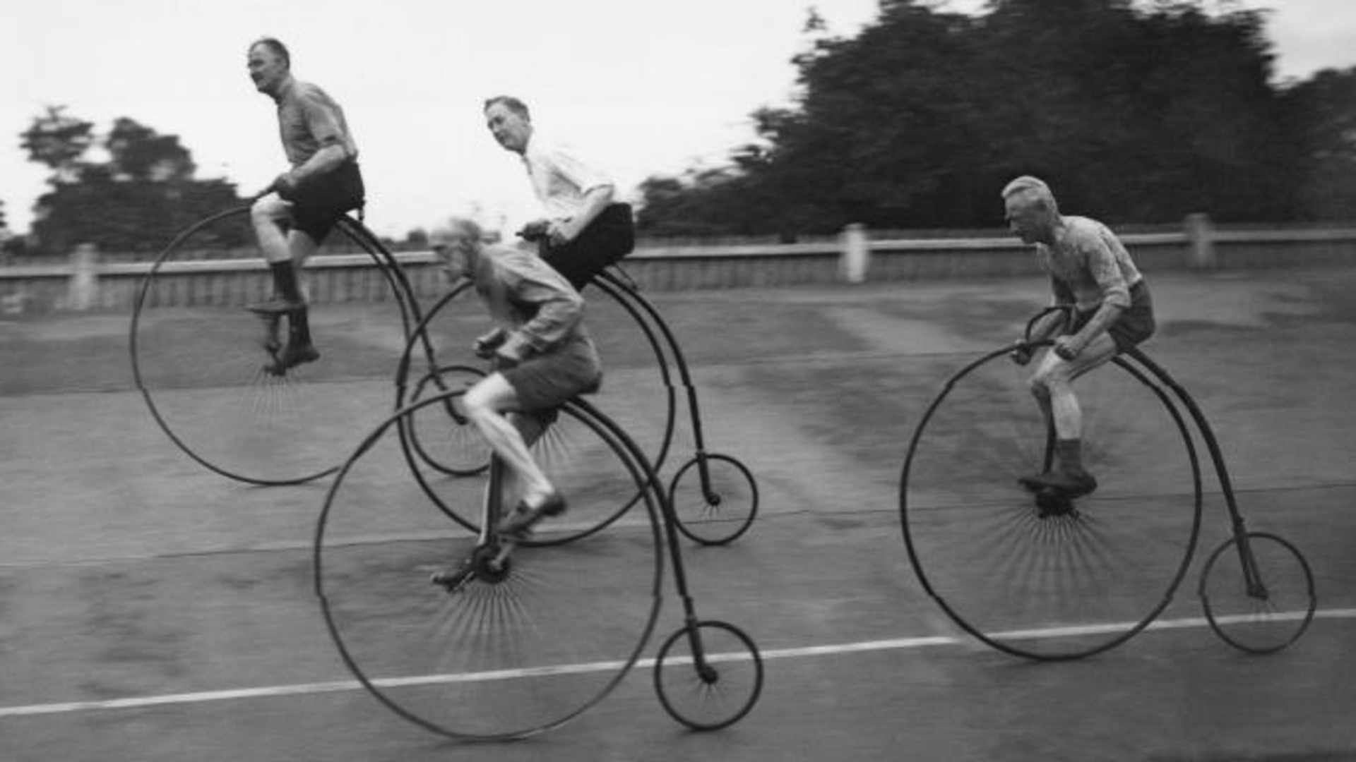 Pedal Your Way Through the Bicycle’s Bumpy History; A group of cycling enthusiasts on their Victorian-style penny farthings, training for a race. (Credit: Douglas Miller/Topical Press Agency/Getty Images)