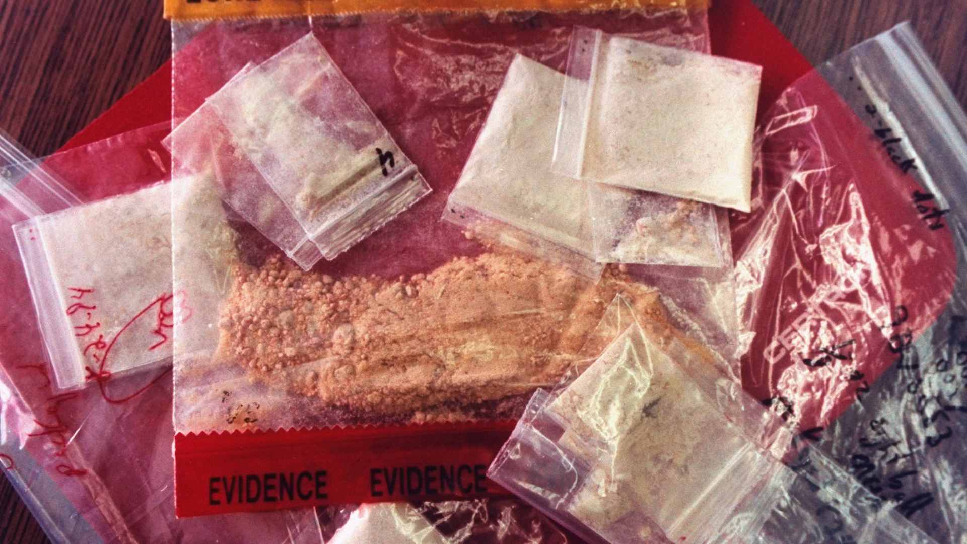 Plastic bags of crank (methamphetamine) in police custody after drug bust