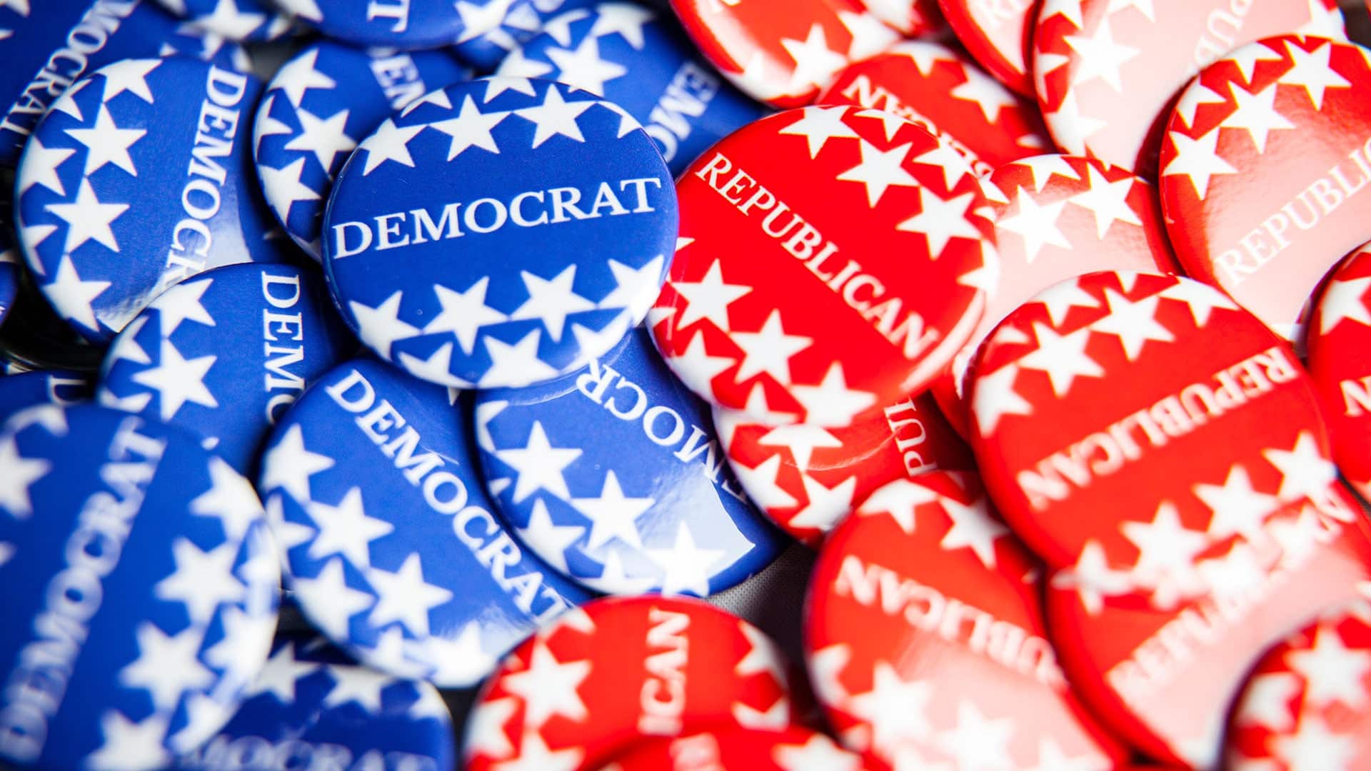 Close up of Vote election buttons, with red, white, blue and stars and stripes. Democrats and Republicans