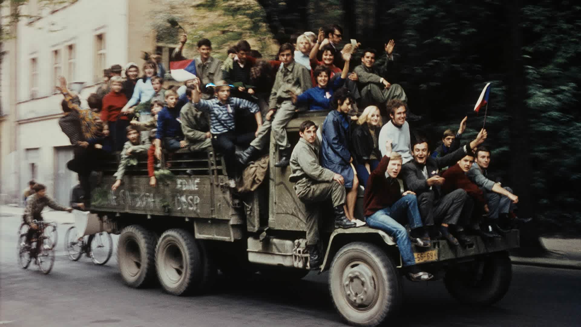 Protesters and residents of Prague, Czechoslovakia ride on a military vehicle on a city street in the capital during the Soviet and Warsaw Pact invasion of the country in August 1968.