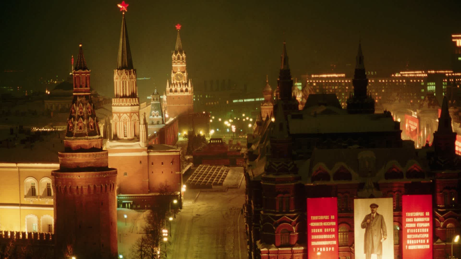 The area around Moscow's Kremlin is lit up at night in 1986. Banners featuring Lenin's face celebrate the 70th anniversary of his revolution are hung on the State Historical Museum in the foreground.