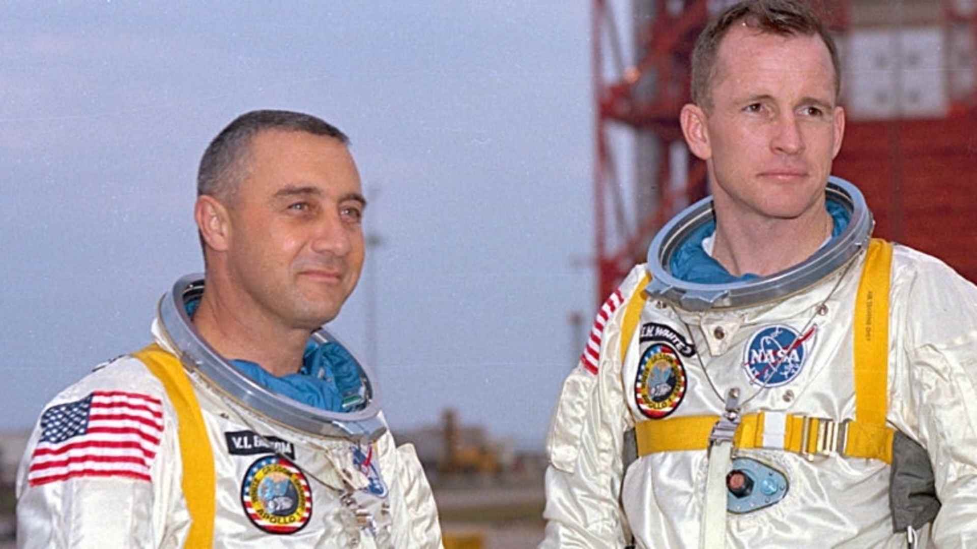 Grissom, White, and Chaffee in front of the launch pad containing their Apollo 1 space vehicle.