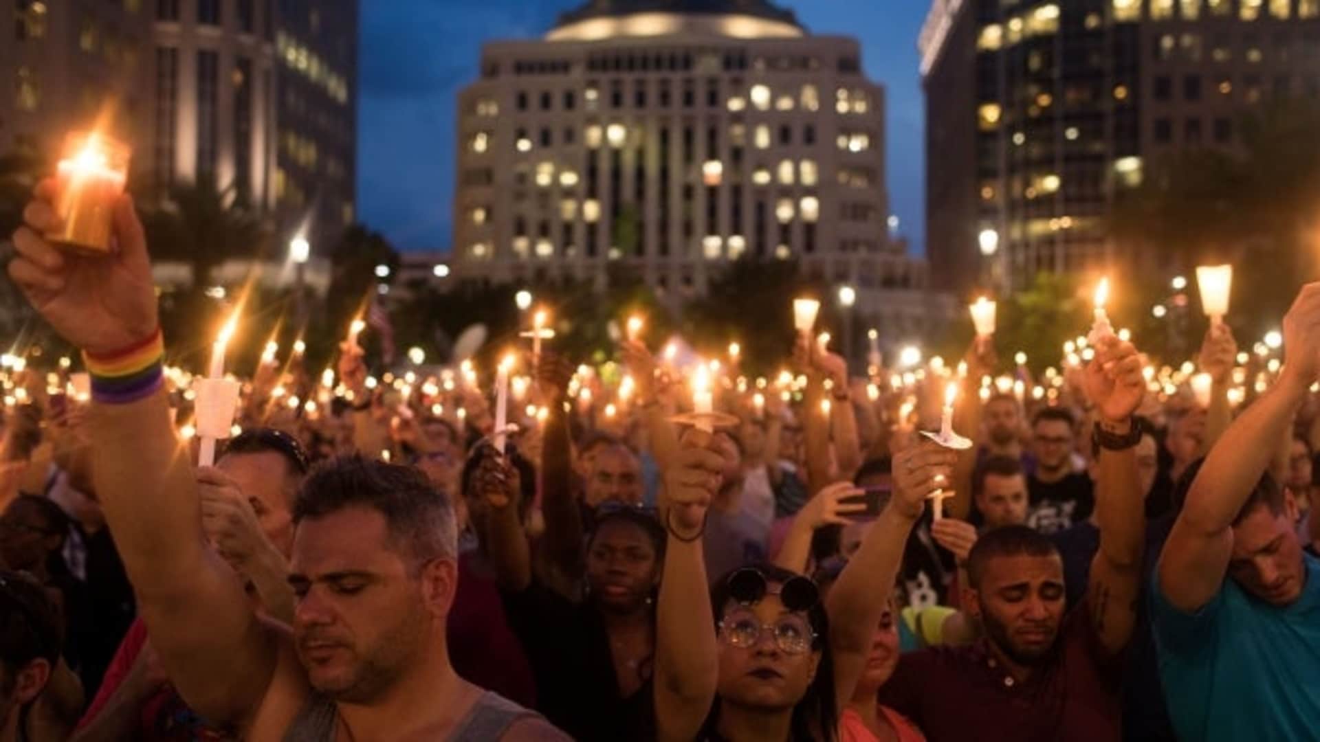 People hold candles during an evening memorial service for the victims of the Pulse Nightclub shootings. (Credit: Drew Angerer/Getty Images)
