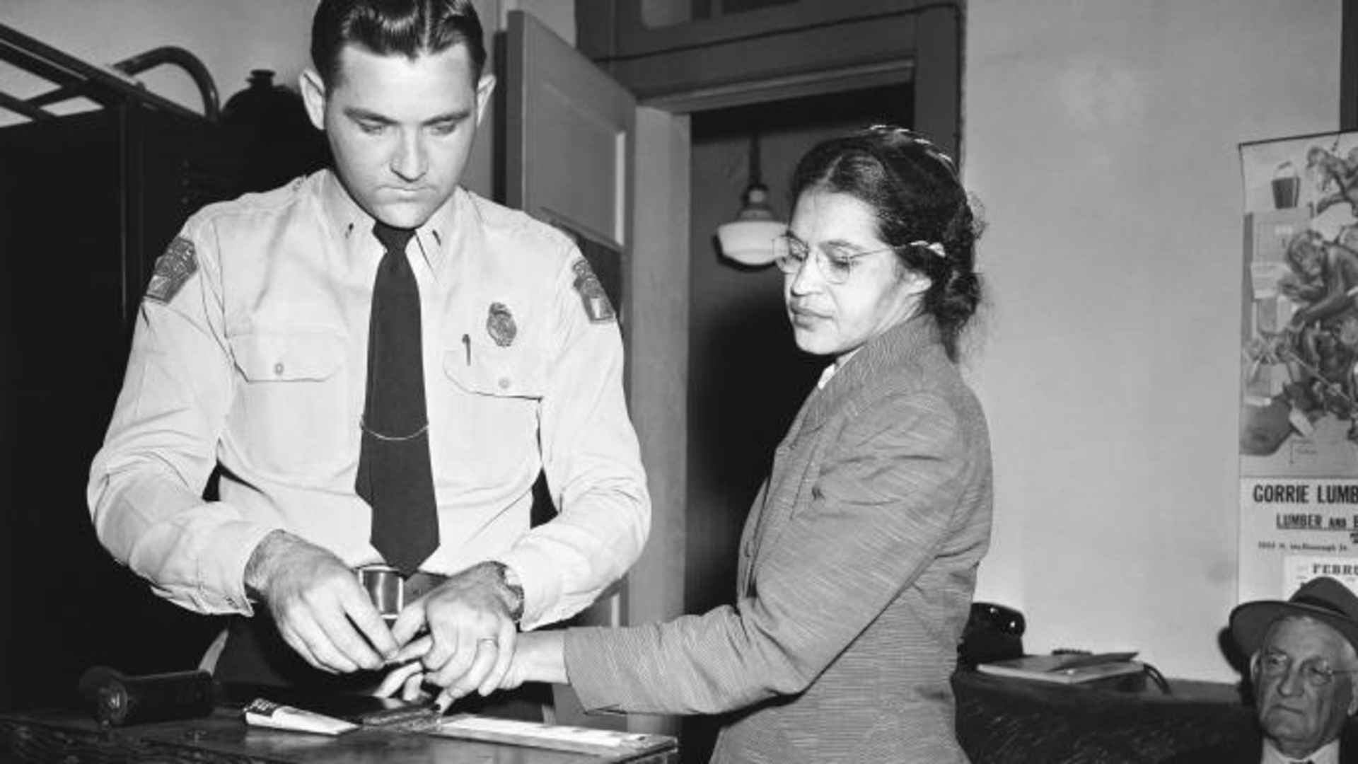 Rosa Parks being fingerprinted by police after refusing to give up her seat on the bus to a white man.
