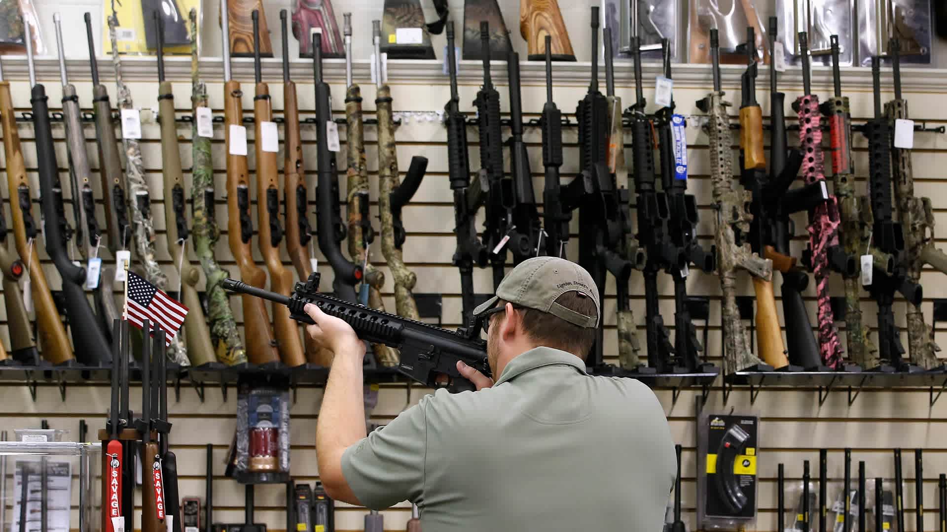 Inside A Gun And Ammunition Store As Debate About Gun Ownership Continues During U.S. Elections A customer holds a AR-15 riffle for sale at a gun store in Orem, Utah, U.S., on Thursday, Aug. 11, 2016. The constitutional right of Americans to bear arms has become a flash point in the presidential contest between Democrat Hillary Clinton and Republican Donald Trump. Photographer: George Frey/Bloomberg via Getty Images