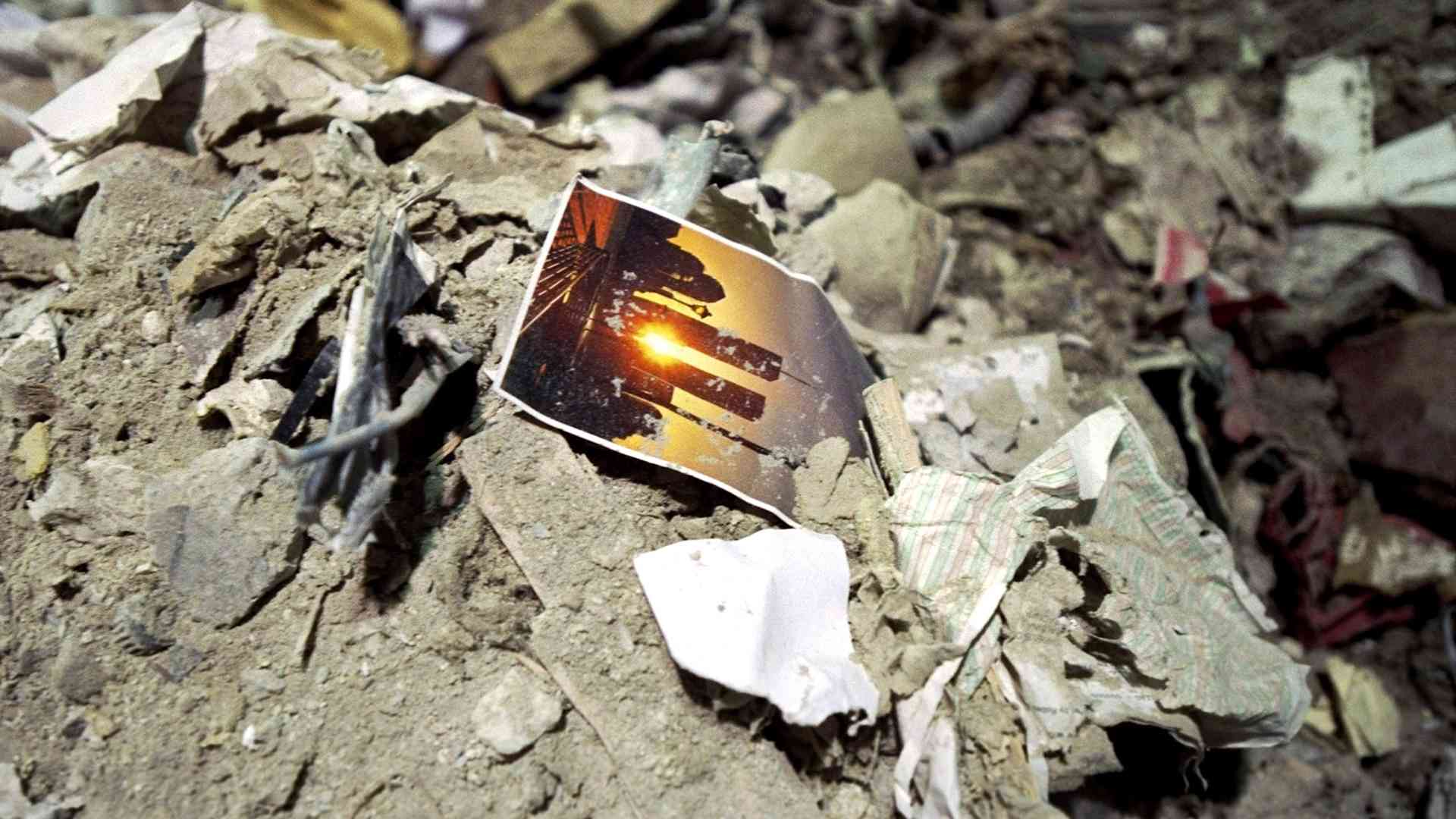 UNITED STATES - SEPTEMBER 14: A postcard picture of the twin towers lies amid the rubble of the World Trade Center, demolished in a terrorist attack.