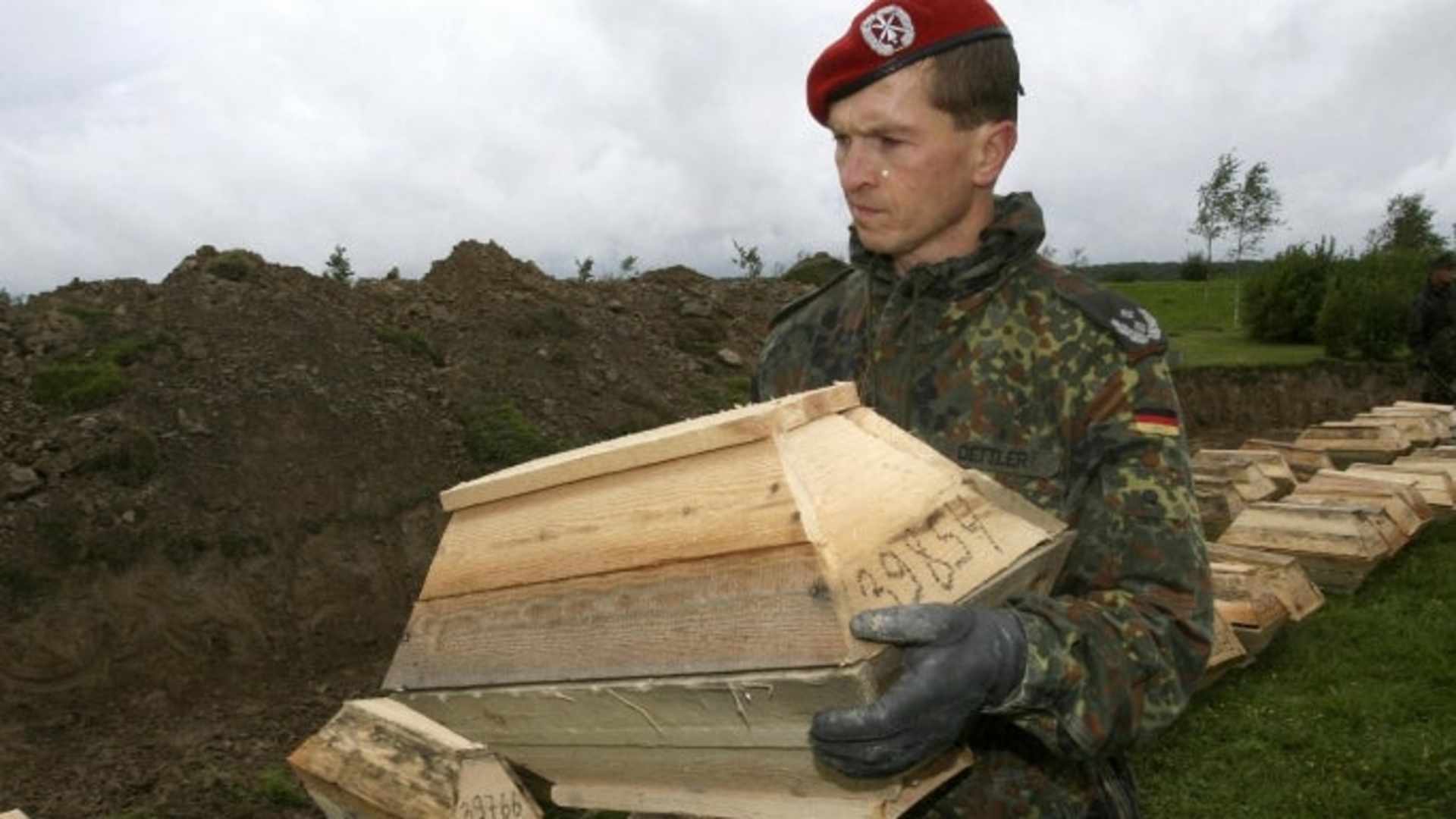 A German soldier prepares remains of World War II soldier for burial at Sologubovka Cemetery near St. Petersburg, Russia in 2007.