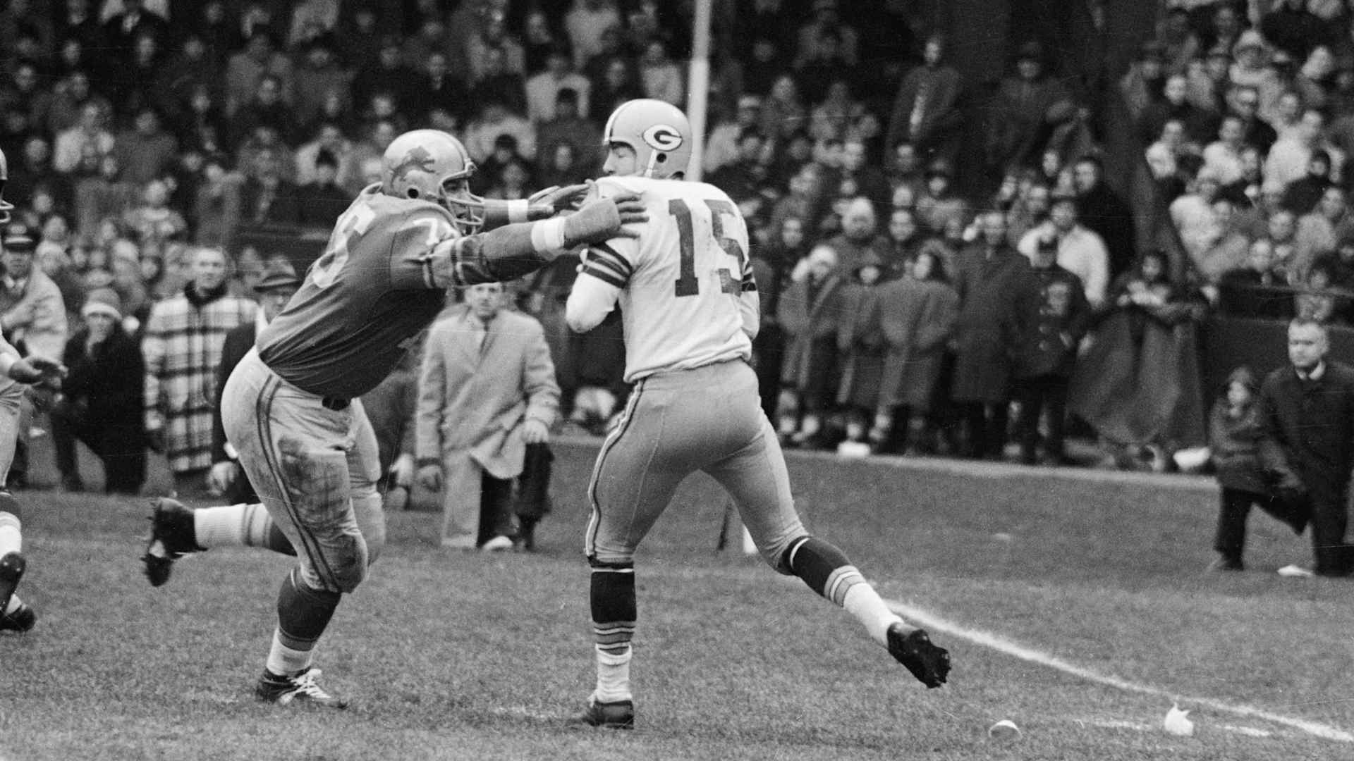 Roger Brown Goes After Bart Starr(Original Caption) 11/22/1962-Detroit, MI- Detroit Lions' Roger Brown (76) goes after Green Bay Packer quarterback Bart Starr (15), who was attempting a pass during the second quarter of the game with the Green Bay Packers November 22nd.