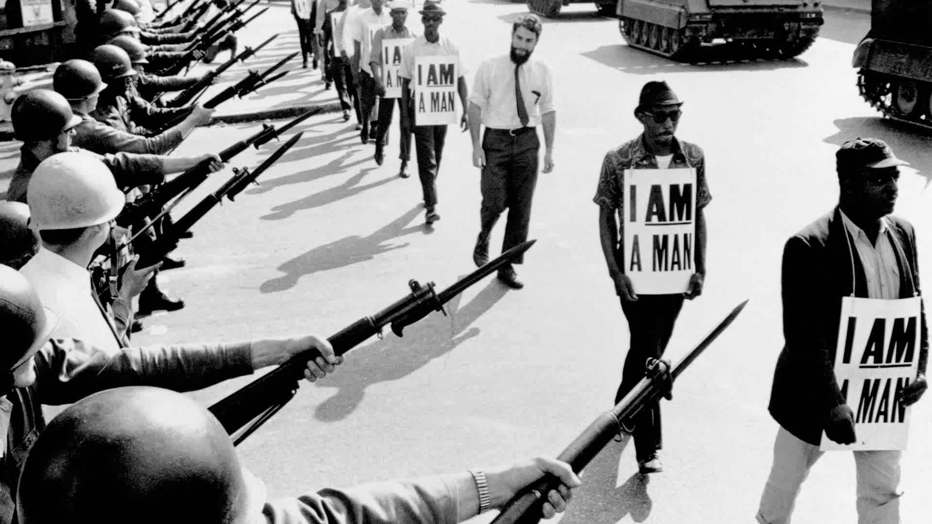Civil Rights Marchers with "I Am A Man" SignsCivil Rights activists are blocked by National Guardsmen brandishing bayonets while trying to stage a protest on Beale Street in Memphis, Tennessee. The marching demonstrators, who are wearing signs which say "I Am A Man," are also flanked by tanks.