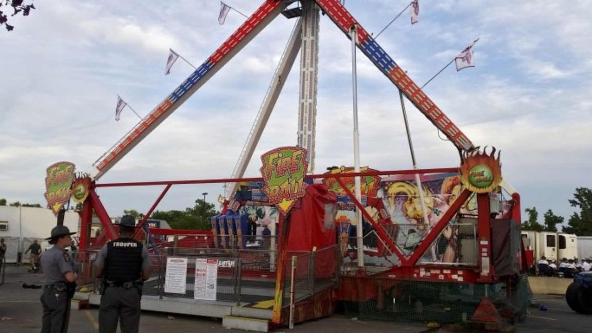 Authorities stand near the Fire Ball amusement ride after it malfunctioned, injuring several at the Ohio State Fair, Wednesday, July 26, 2017, in Columbus, Ohio.