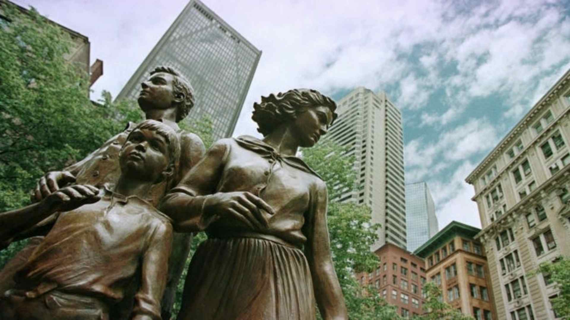 Statues created by artist Robert Shure depicting a hopeful Irish family landing in Boston as part of the Irish Famine Memorial. (Credit: Victoria Arocho/AP Photo)