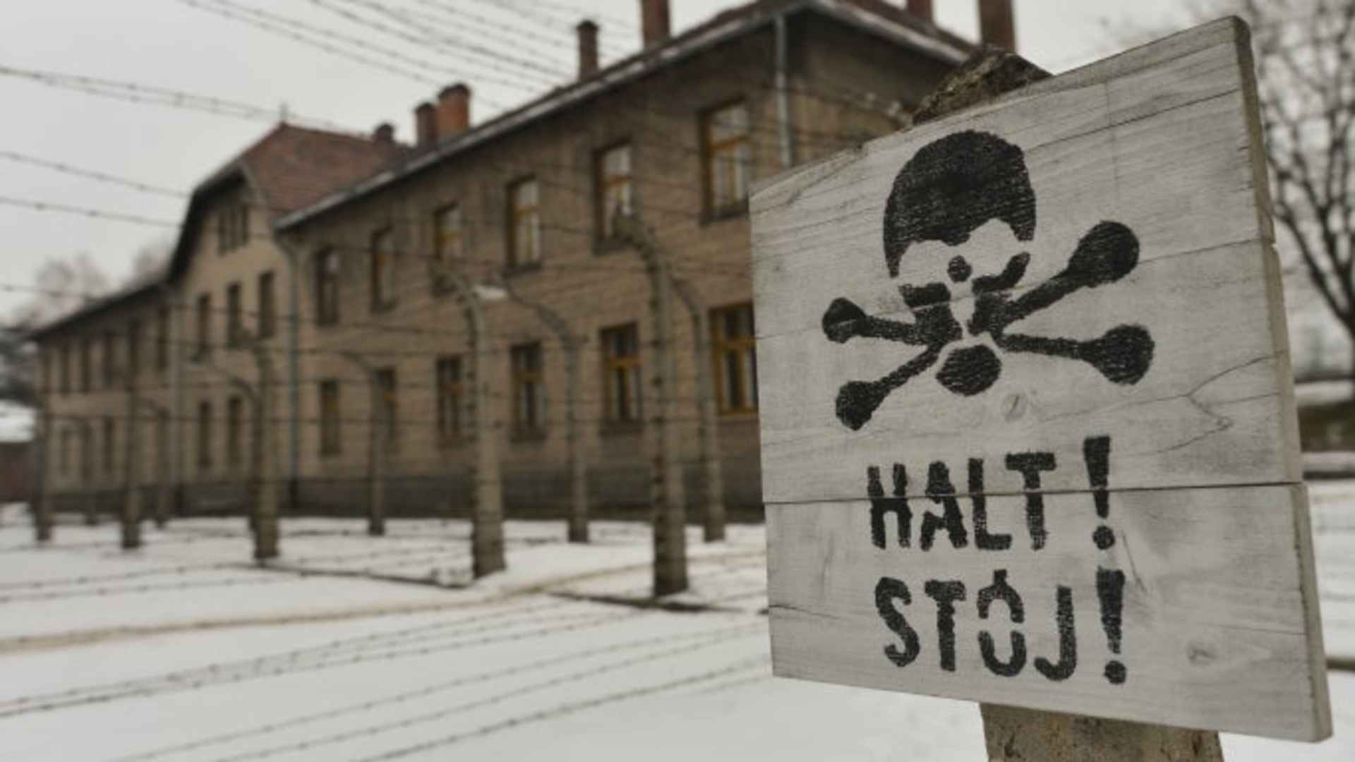 A warning sign near the entrance to the former Auschwitz camp. (Credit: Artur Widak/NurPhoto/Getty Images)