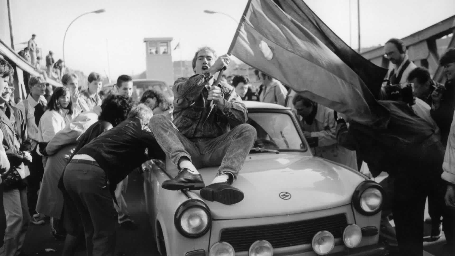 An excited crowd crossing the border at the Bornholm Bridge after the fall of the Berlin Wall.  (Credit: Brigitte Hiss/ullstein bild via Getty Images)