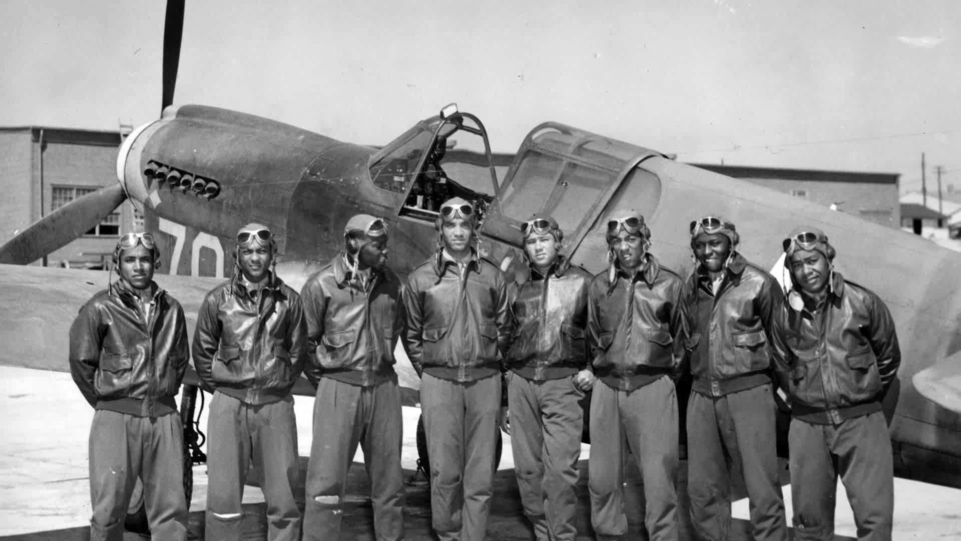 Pilot CommissionsTuskegee Airmen stand with an airplane and prepare to receive commissions and wings from Colonel Kimble, Commanding Officer of the Tuskegee Army Flying School, Tuskegee, Alabama, 1942. (Photo by Afro American Newspapers/Gado/Getty Images)