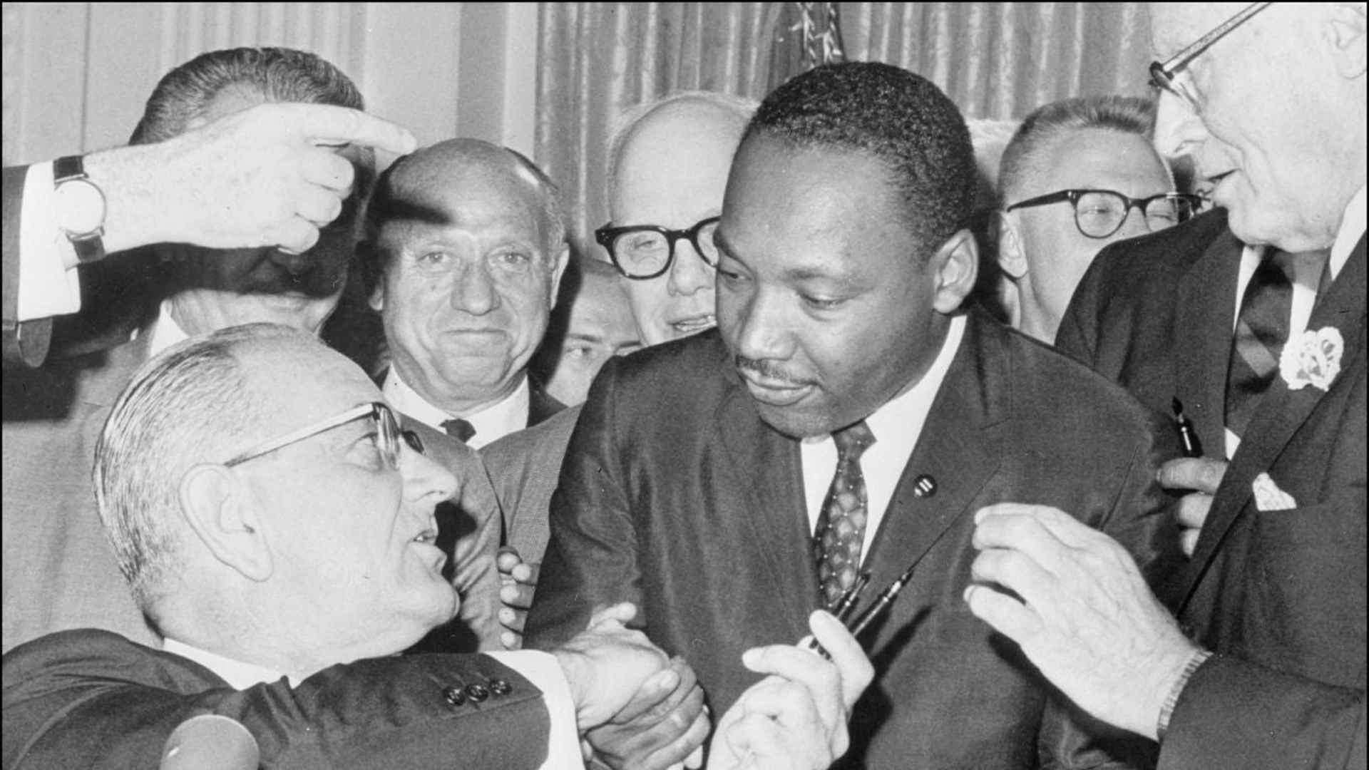 Martin Luther King Jr. shakes hands with President Lyndon B. Johnson at the signing of the 1964 Civil Rights Act.