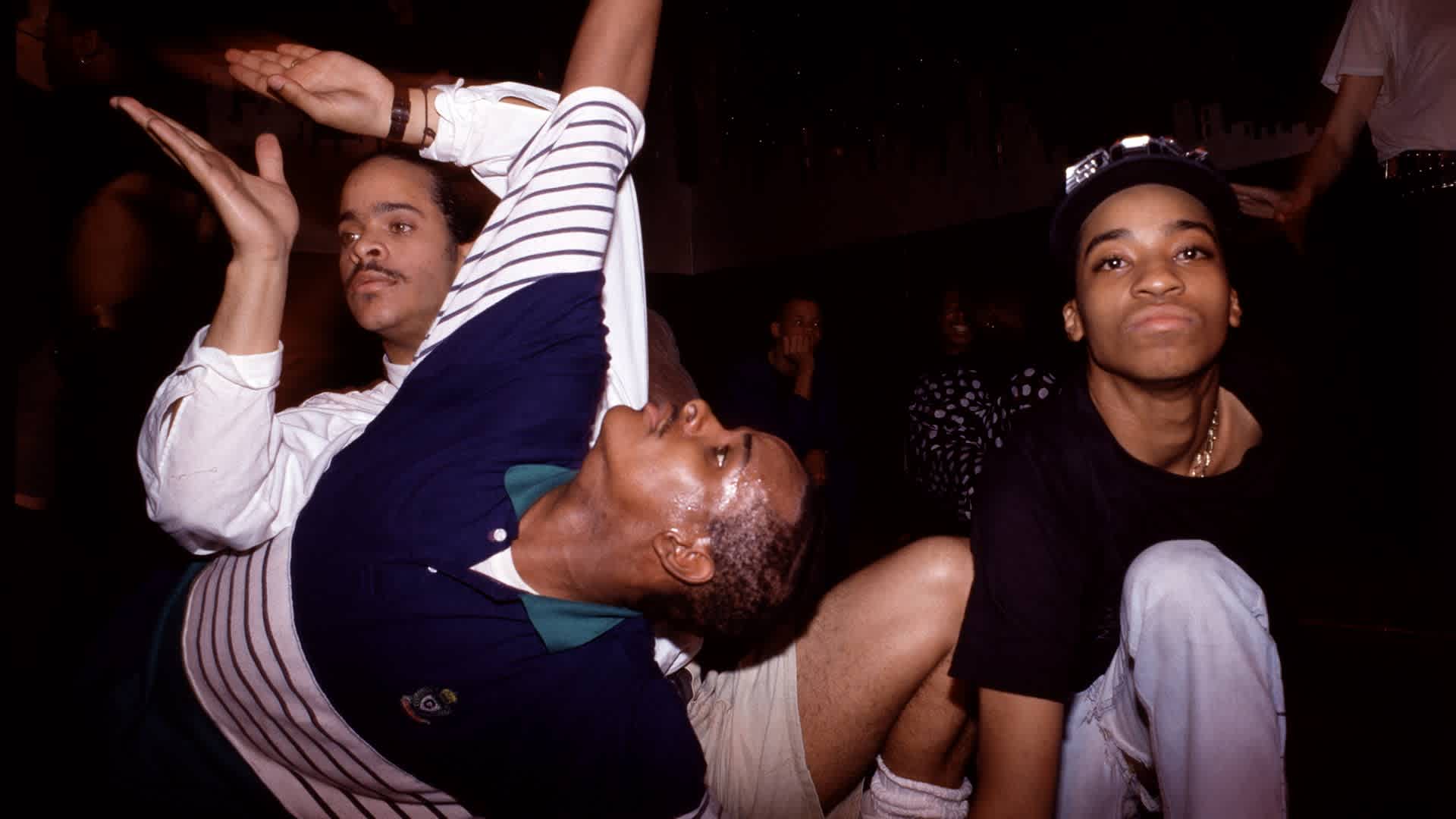 From left, vogue dancers Cesar Valentino (white shirt), Derrick Xtravaganza Huggins, and Fidel perform at the Copacabana nightclub, New York, New York, May 25, 1989. (Photo by Rita Barros/Getty Images)