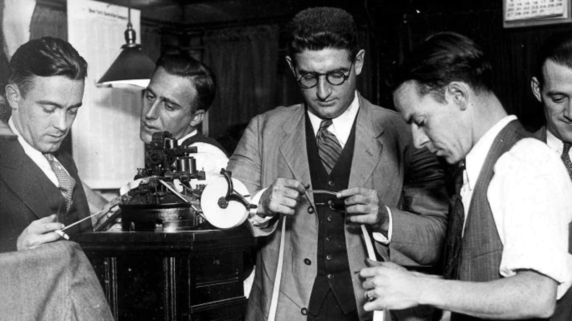 Employees of the New York stock Exchange checking the ticker tape, November 1929. (Credit: Ullstein Bild/Getty Images)