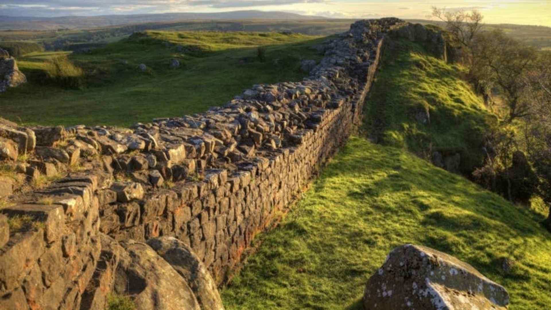 A stretch of Hadrian's Wall at Walton's Crags in Northumberland, England, coloured by the setting sun
