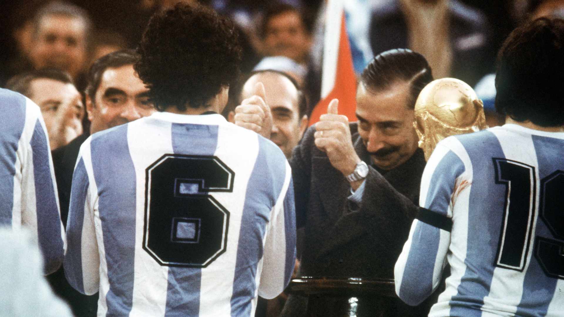 General Jorge Videla, chief of the Argentinian Junta, presenting the World Cup trophy to Argentina's team captain Daniel Passarella at the Buenos Aires River Plate stadium.