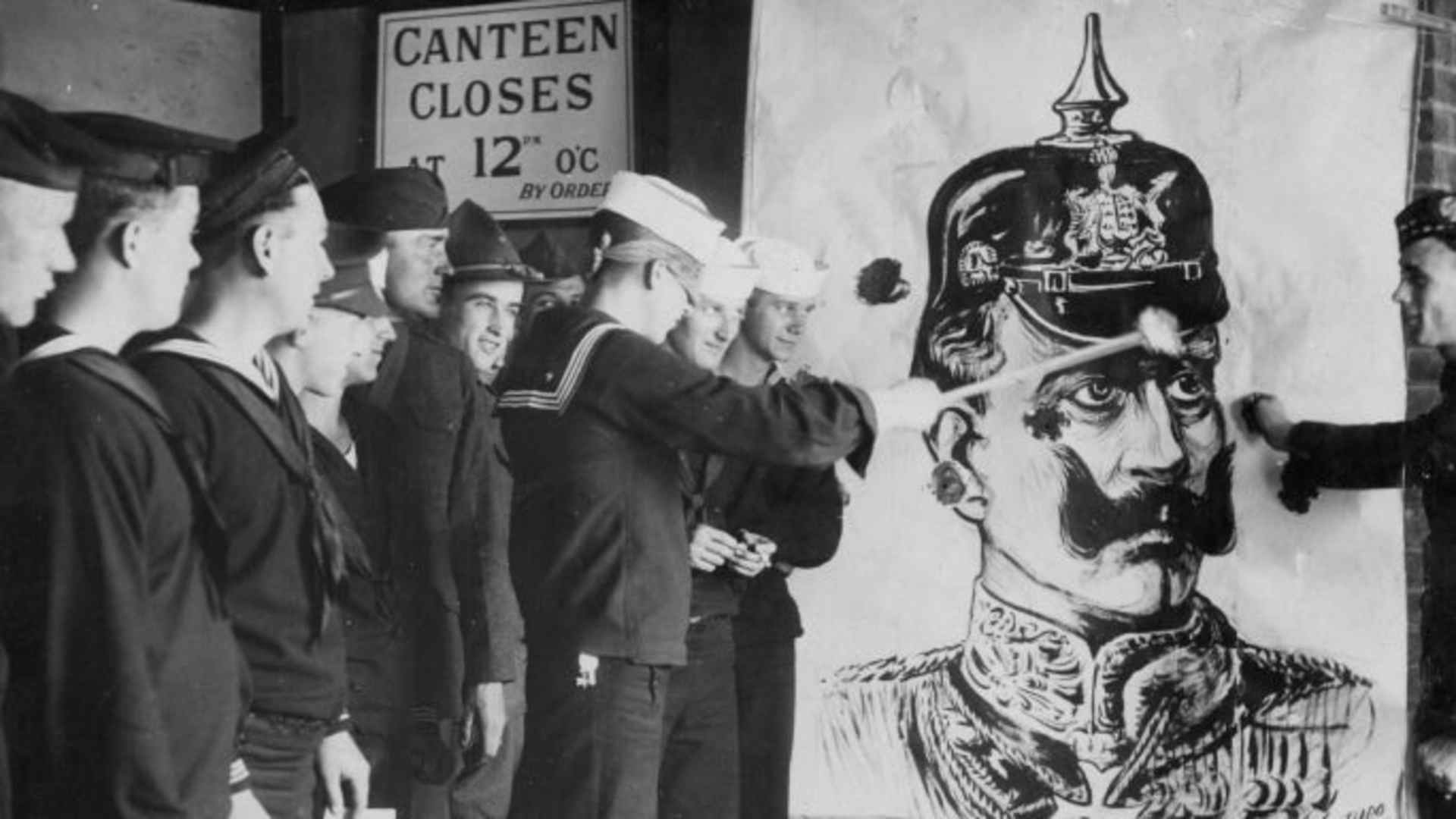 American troops throwing darts at a picture of the German Kaiser during World War One. (Credit: Paul Thompson/FPG/Archive Photos/Getty Images)