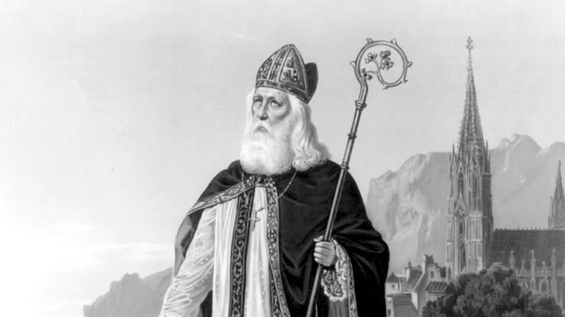 St. Patrick pray for your children, printed on open book with saint in foreground, church in background ca. 1888St. Patrick pray for your children, printed on open book with saint in foreground, church in background ca. 1888. (Photo by: HUM Images/Universal Images Group via Getty Images)