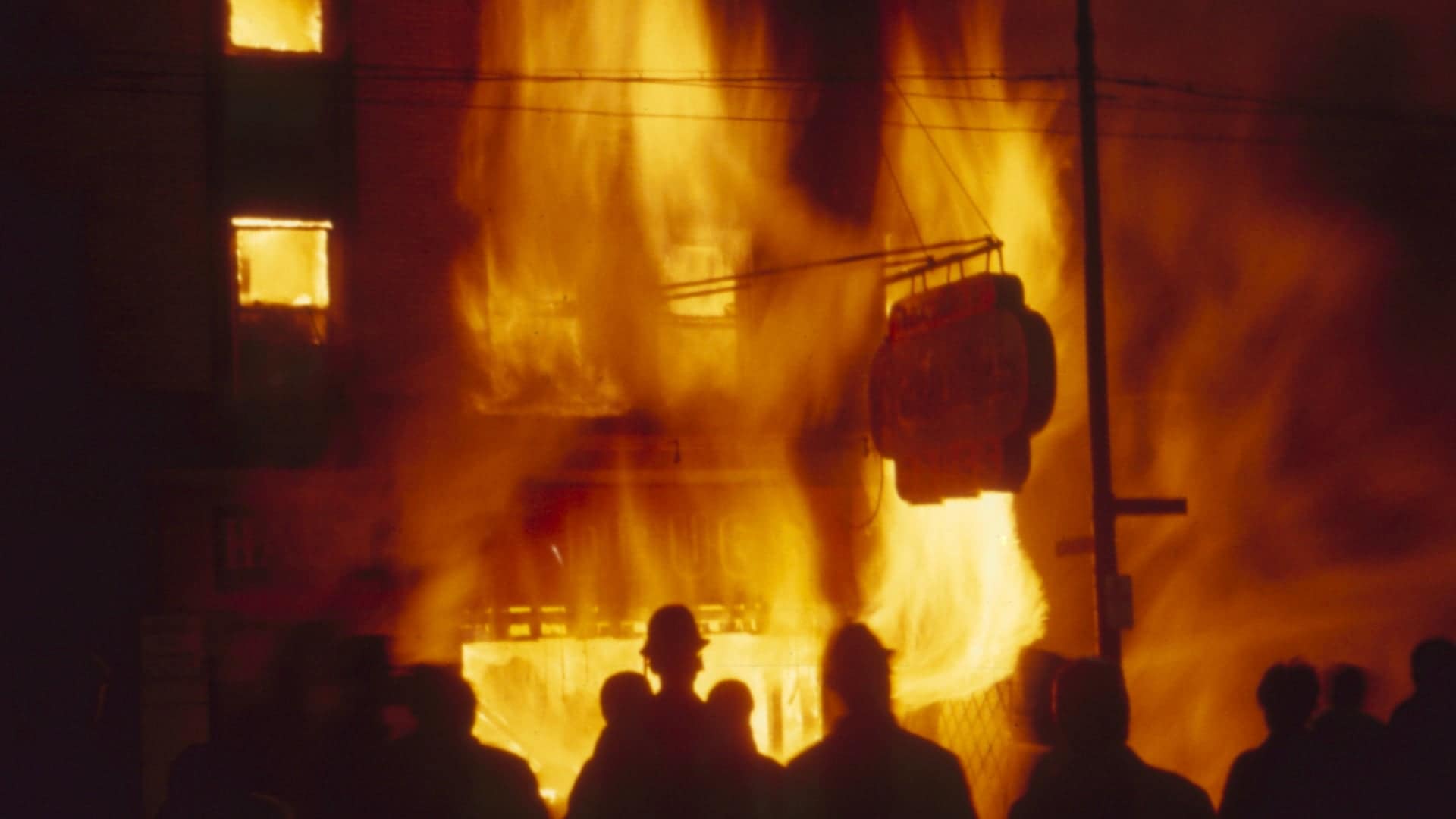 Onlookers watch as a Chicago storefront building burns during riots in the wake of Martin Luther King Jr's assassination, 1968. (Credit: Lee Balterman/The Life Picture Collection/Getty Images)