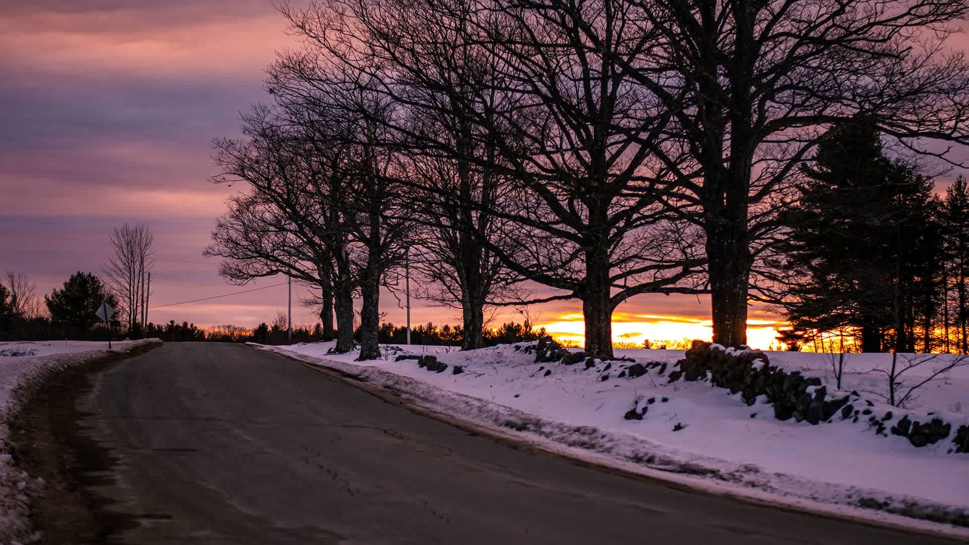 A road in Maine in winter at dusk.