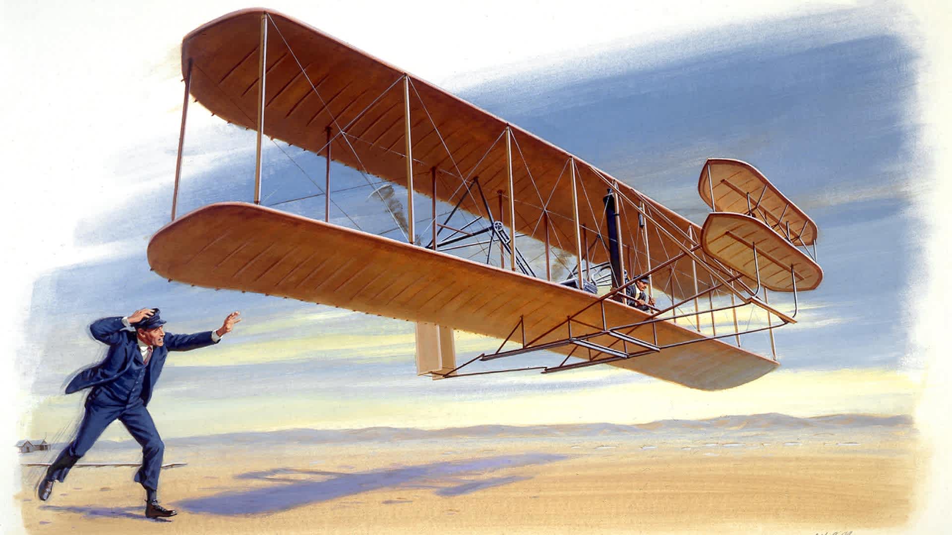 A painting depicting Orville Wright piloting the Wright Flyer 1 and being chased by his brother Wilbur Wright during the first manned flight on December 17, 1903 at Kill Devil Hills, North Carolina. Painting by Ed Vebell