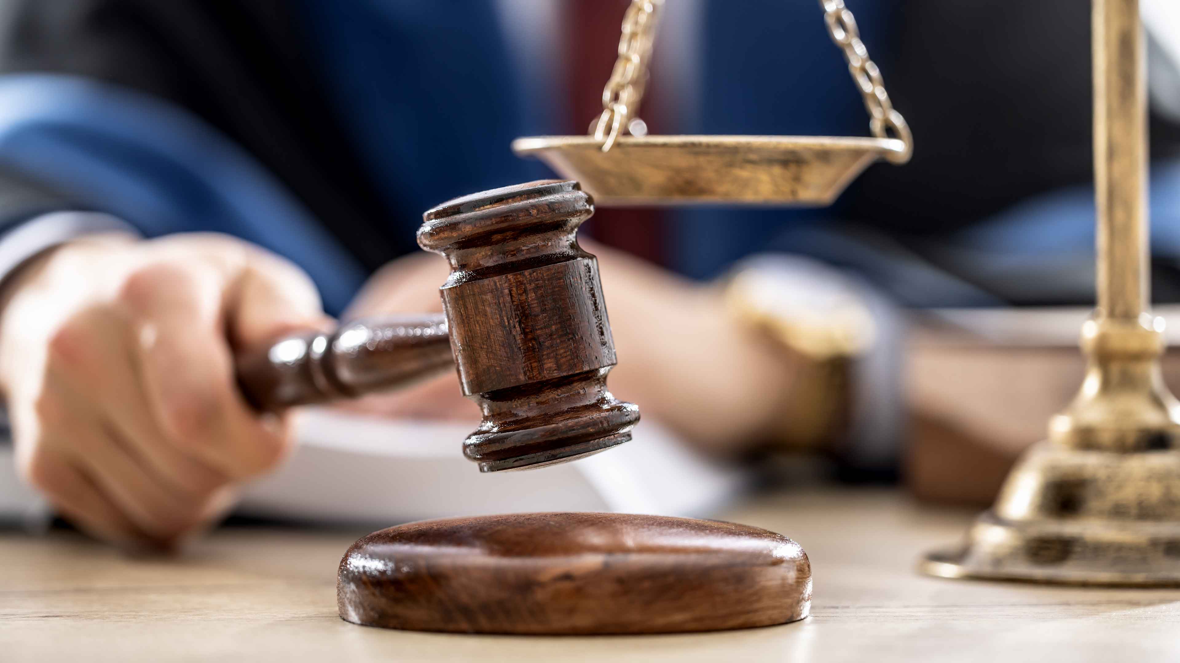 Symbols of law a legal system - a judge, gavel and scales representing jurisdiction.