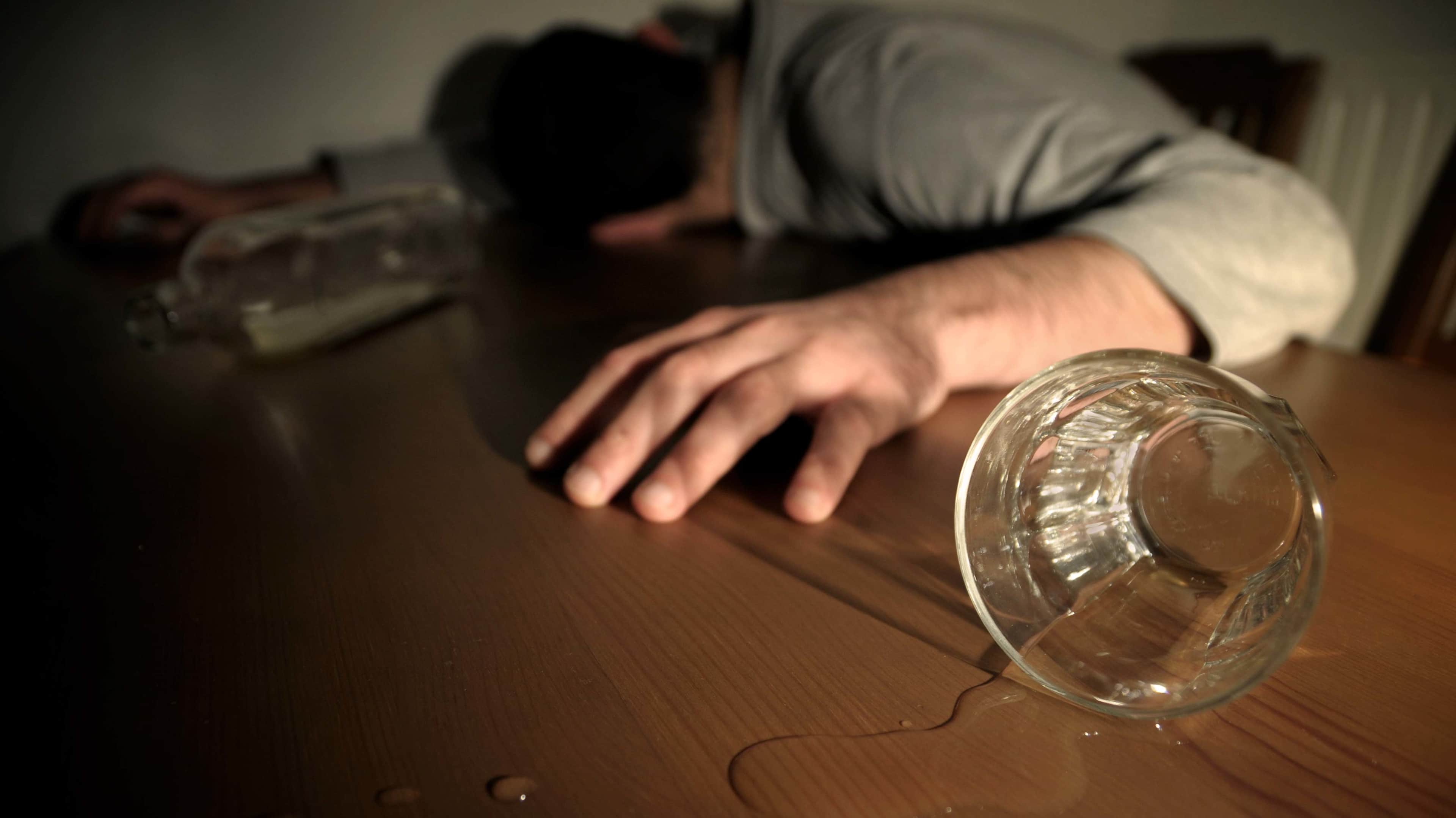 Alcoholism Concept Man Drunk Laying on the Table