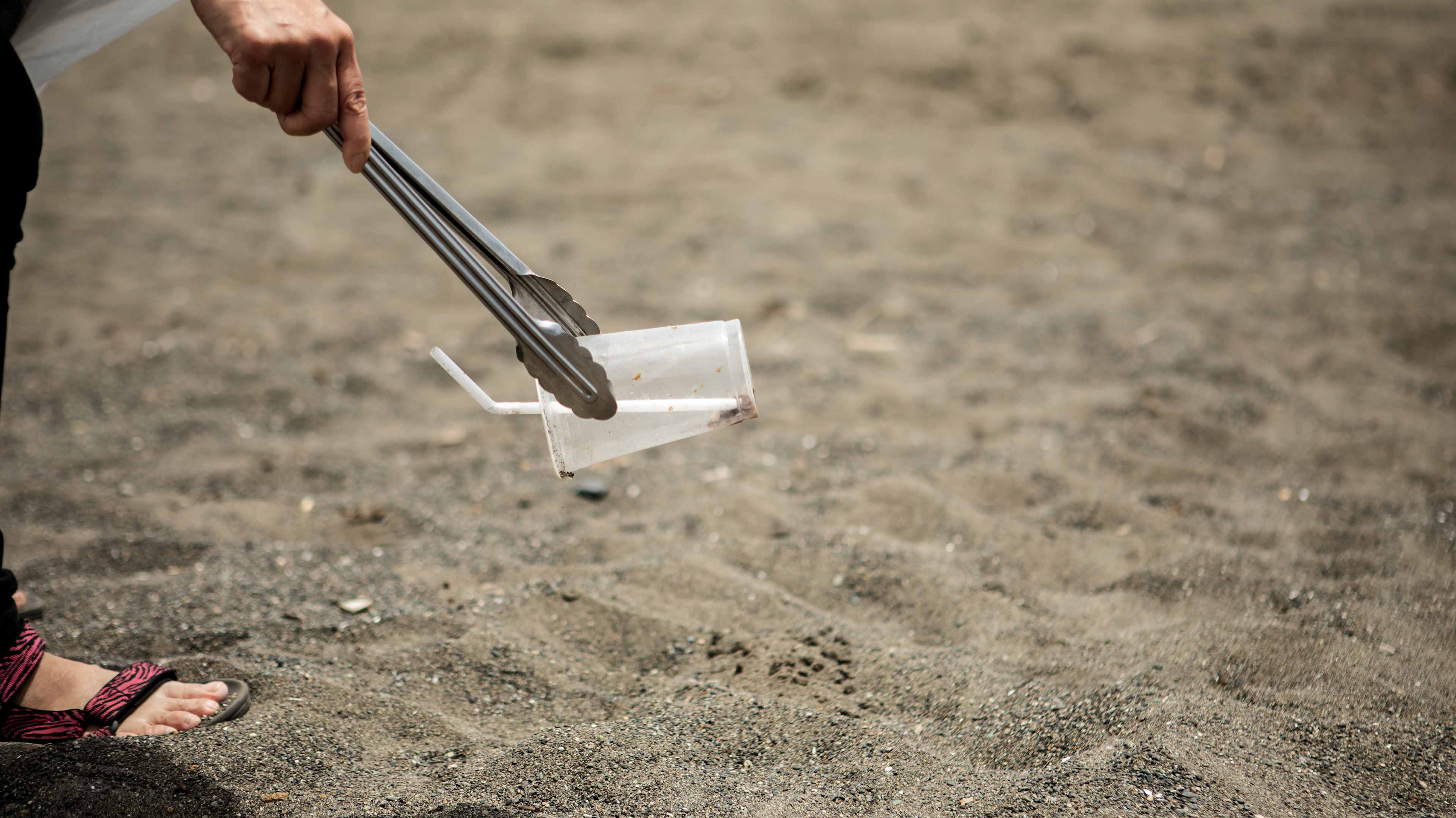 Volunteer group members picking up trash on the beach