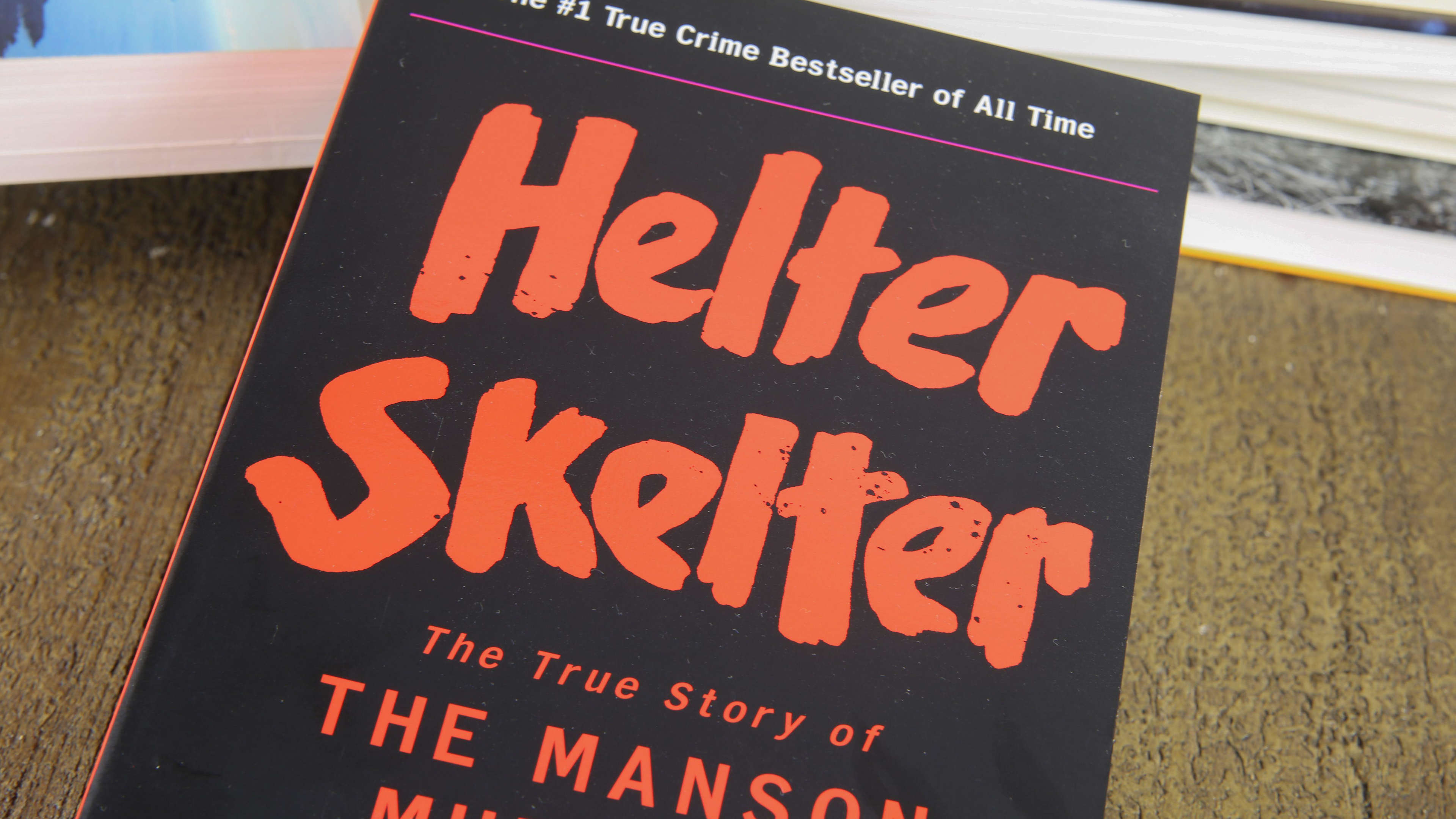 Viersen, Germany - May 9. 2020: View on isolated  book cover about story of manson murders with pile of books background